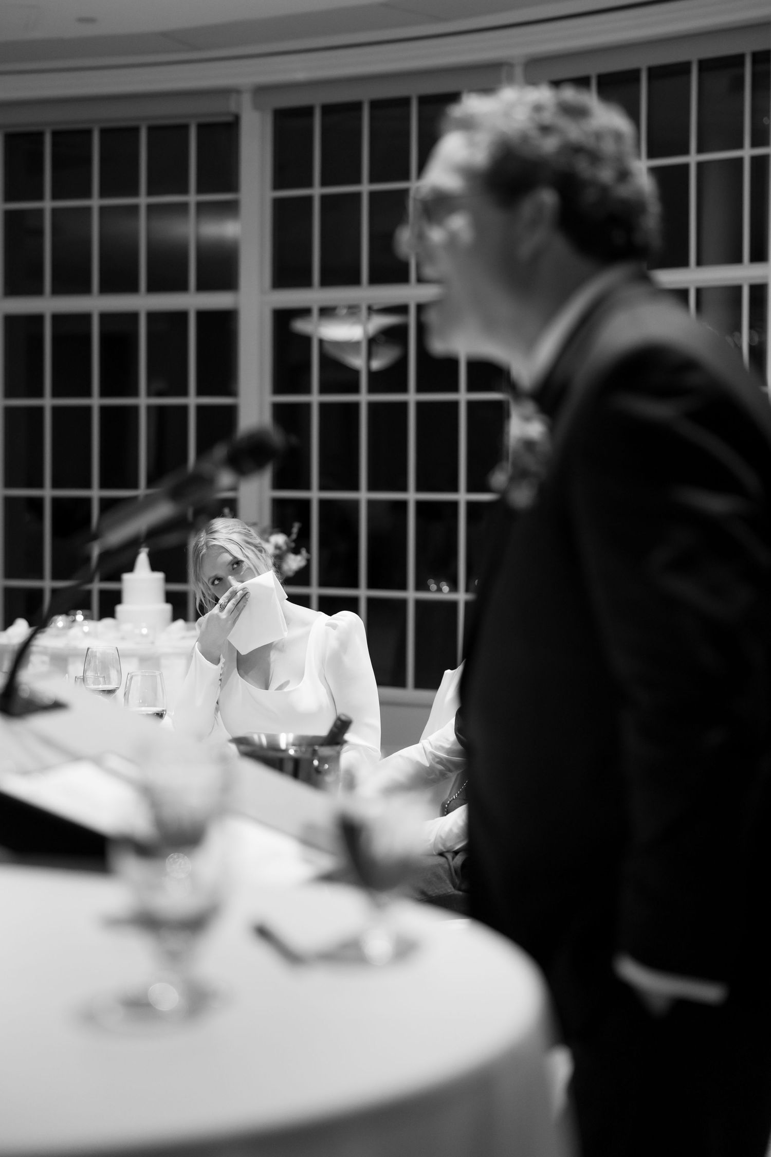 Wedding guests seated at elegantly decorated tables during a reception dinner.