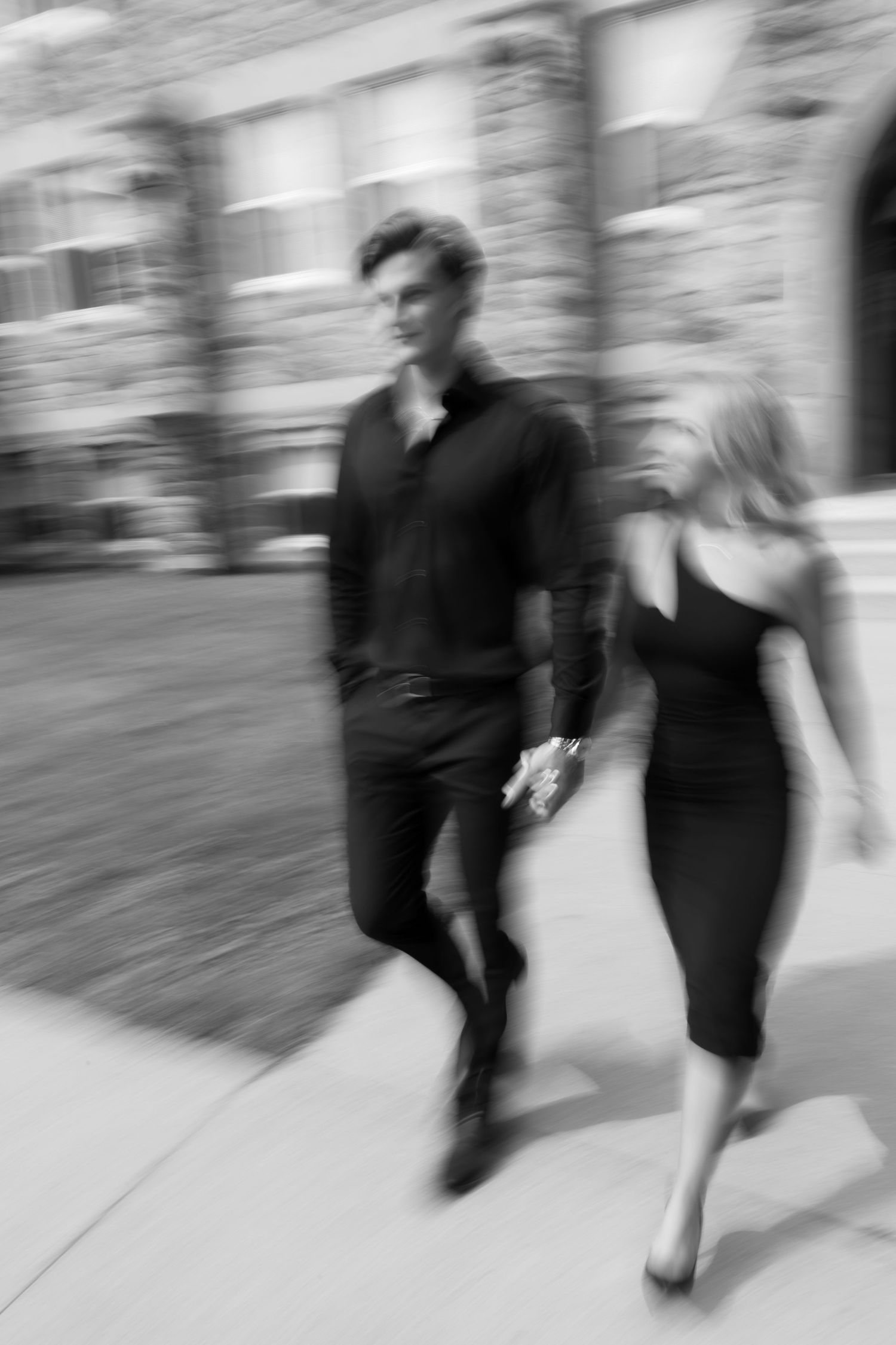 Artistic motion blur photo of a couple walking in black and white.