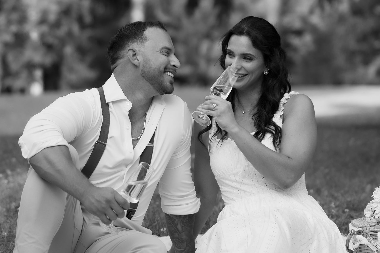 A couple shares tender romantic moments in a series of black and white wedding photos outdoors.