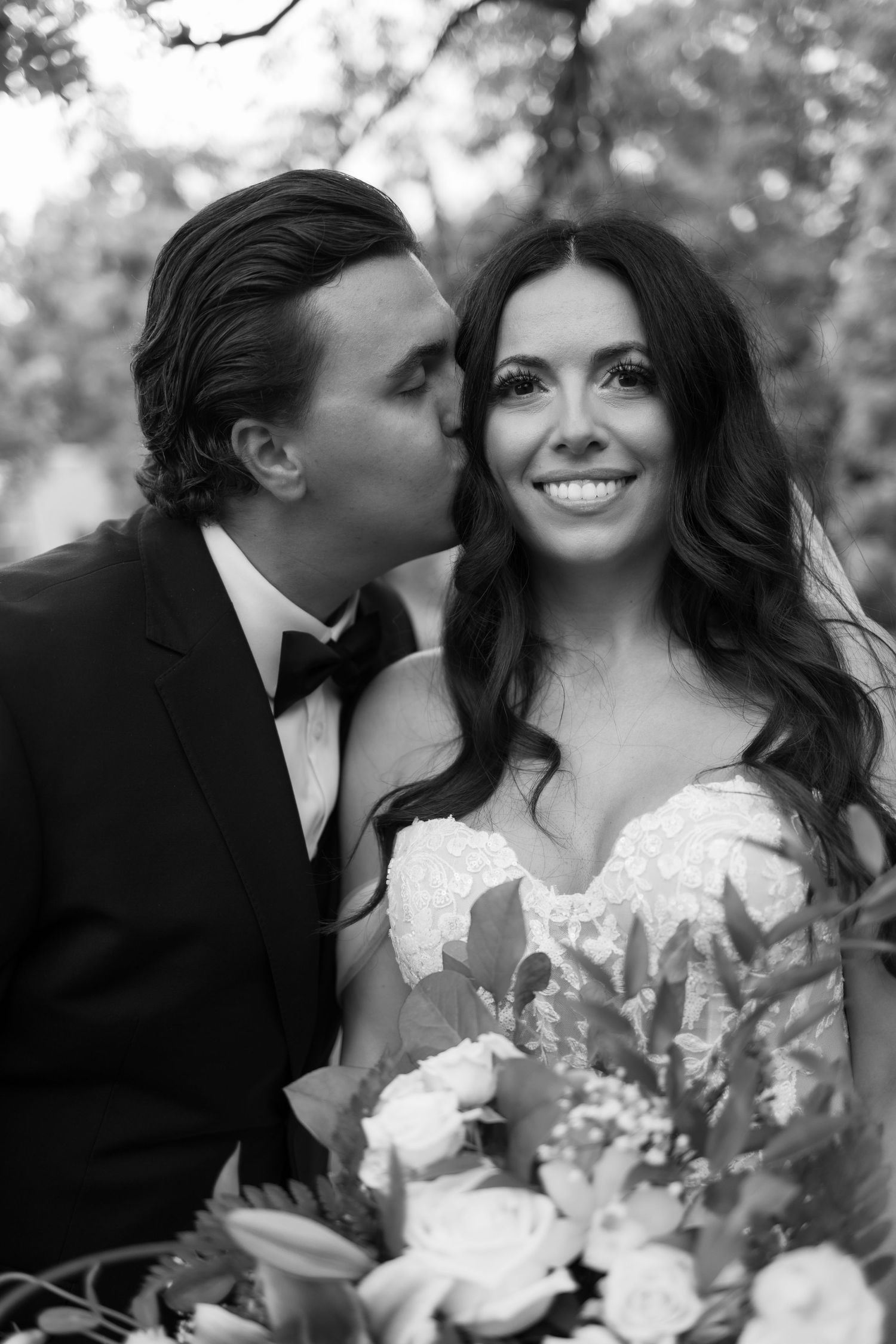 Intimate black and white wedding portraits with a stunning floral bouquet.