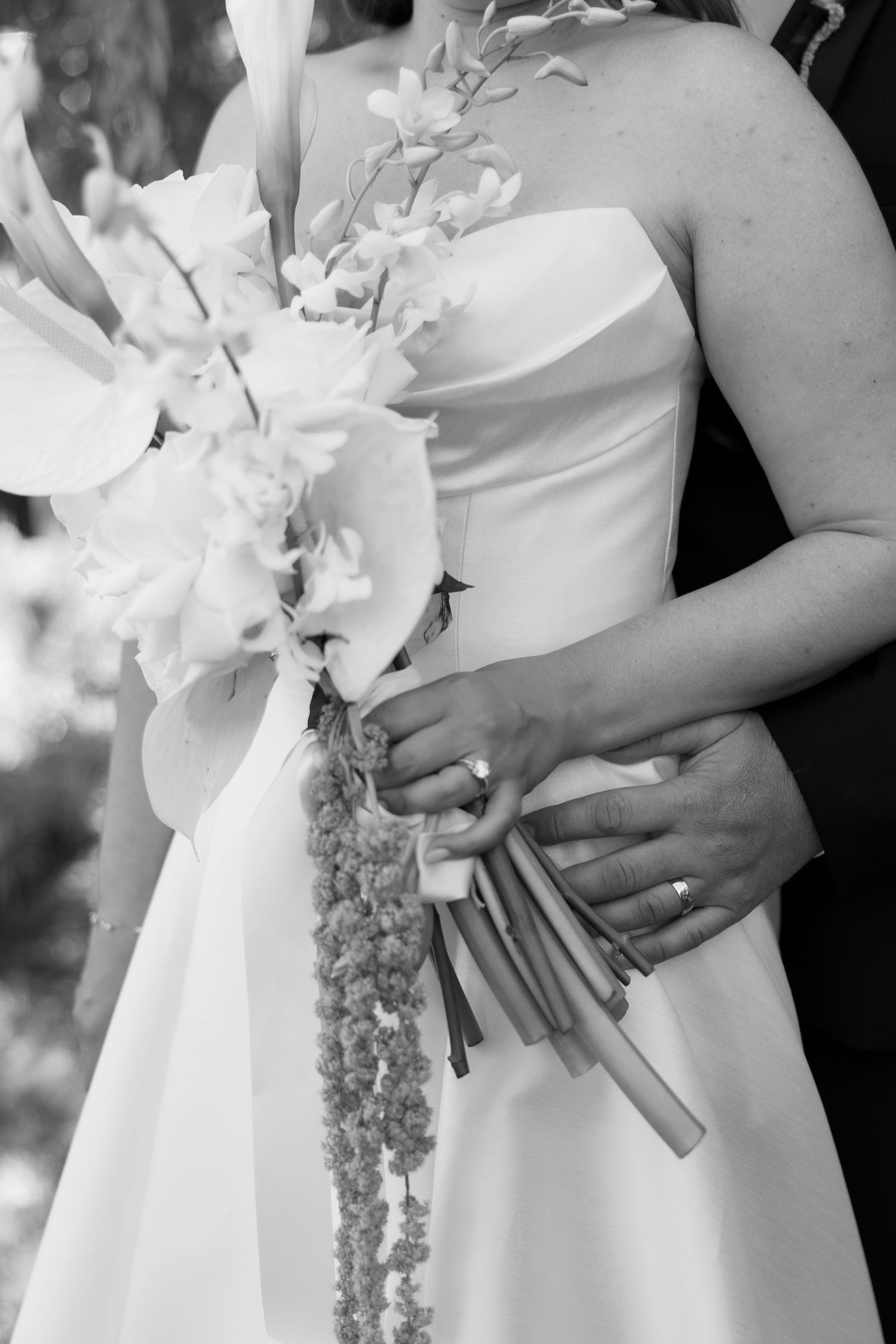 Close-up of white bridal bouquet with elegant flowers in black and white.