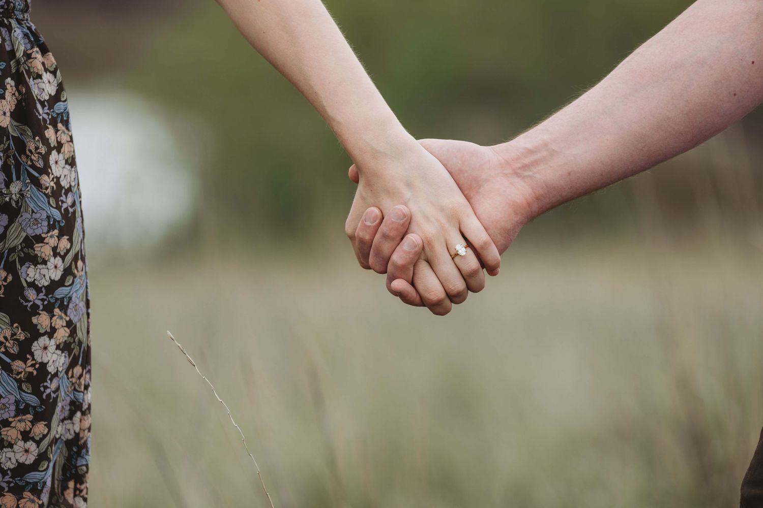 A close up of a couples hands just after a proposal.