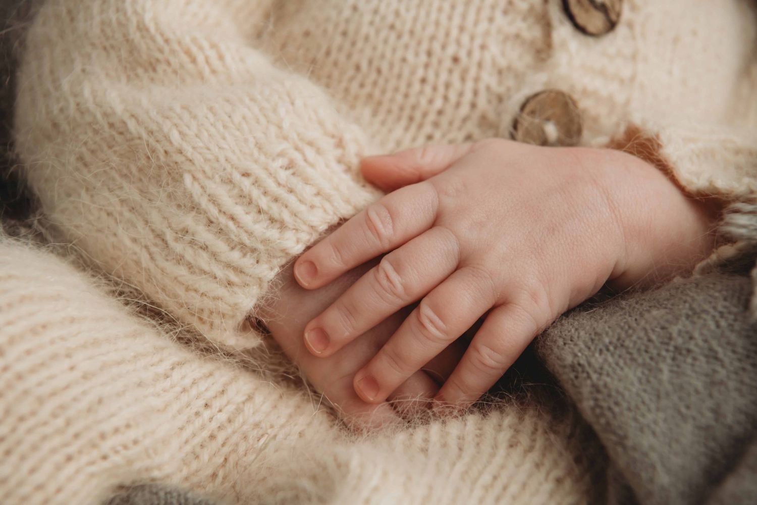 A close-up image of a newborn baby's hands.