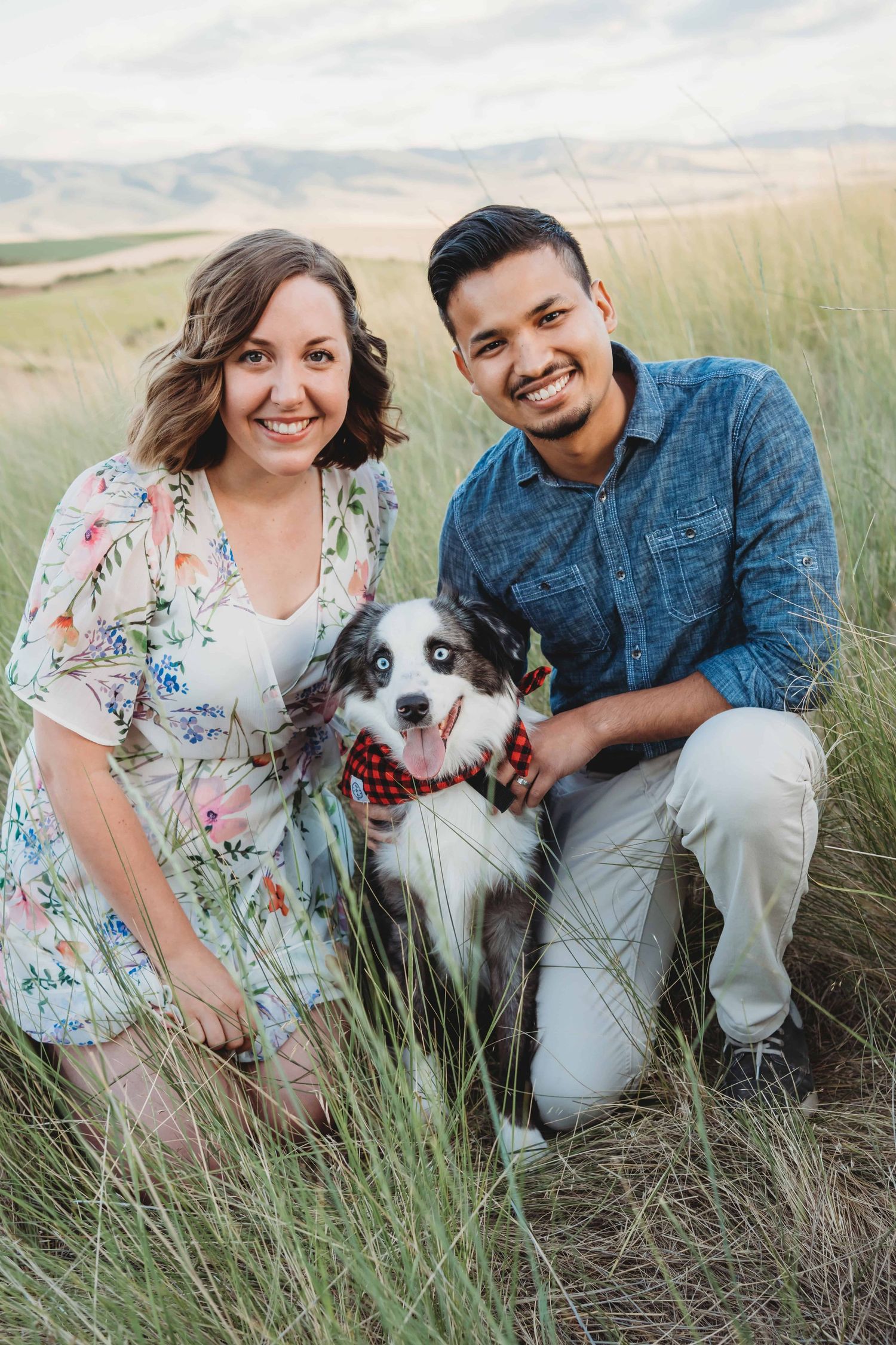 Couple smiling with their dog during an outdoor couples session in the Walla Walla at Bennington Lake.