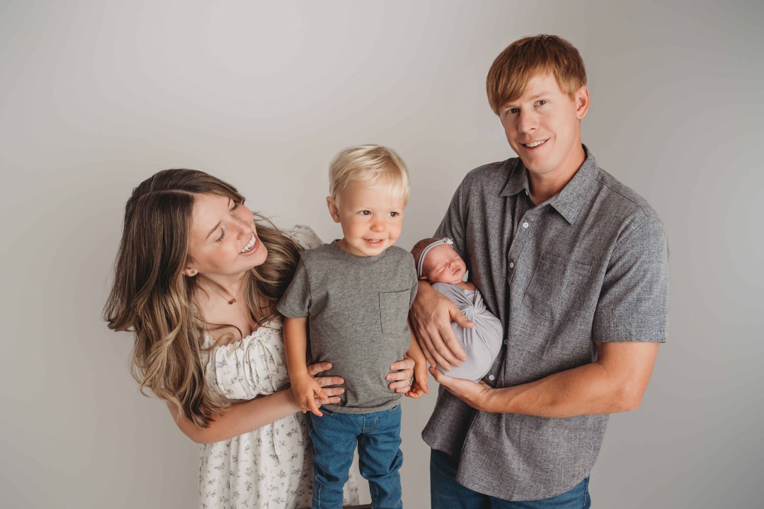 A candid portrait of a Walla Walla family with their newborn and toddler in studio.