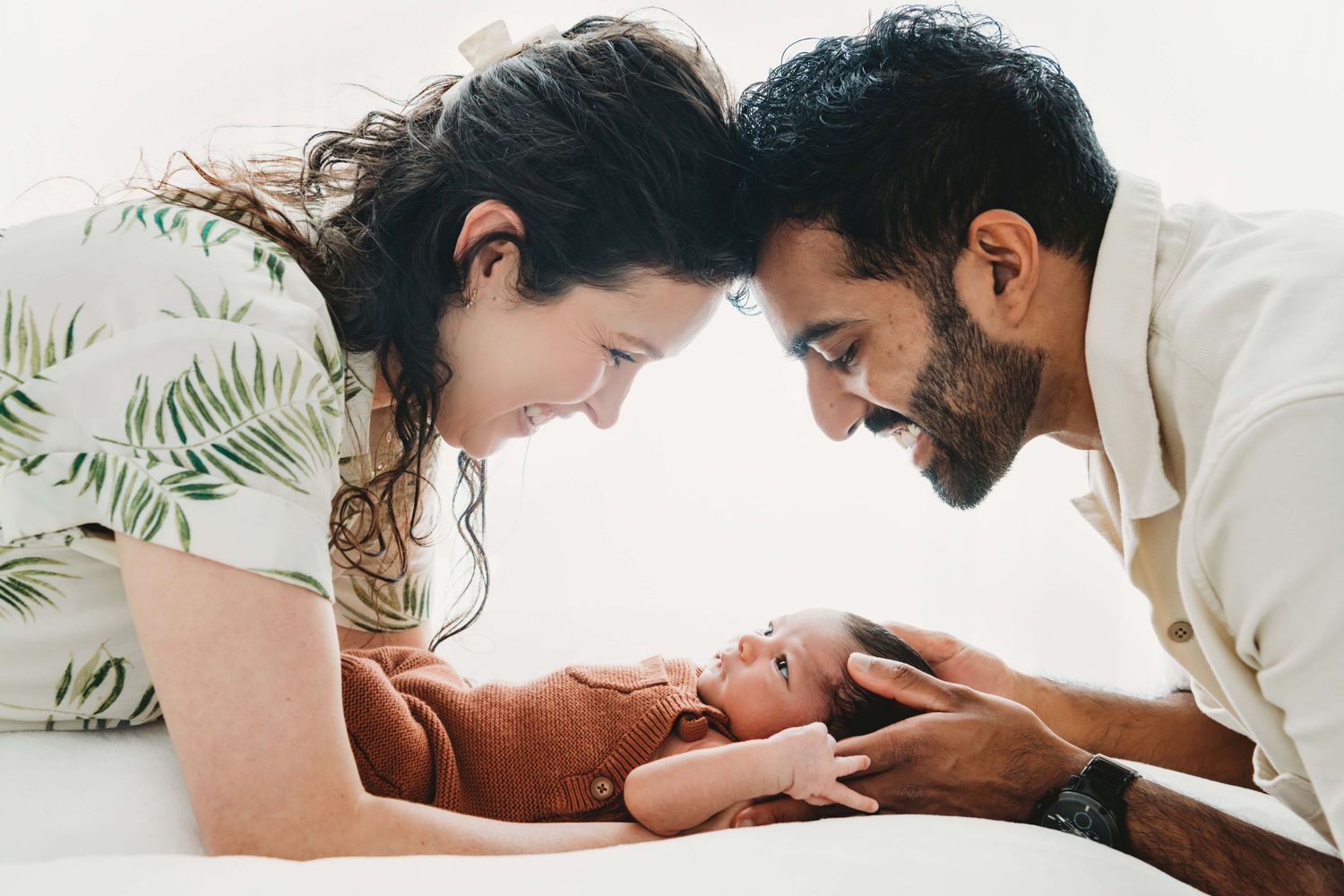 Parents looking down at their newborn baby boy.