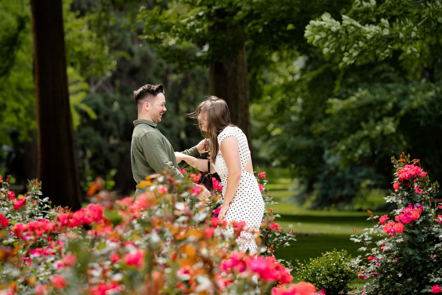 A woman laughing excitedly just after her boyfriend proposed to her.