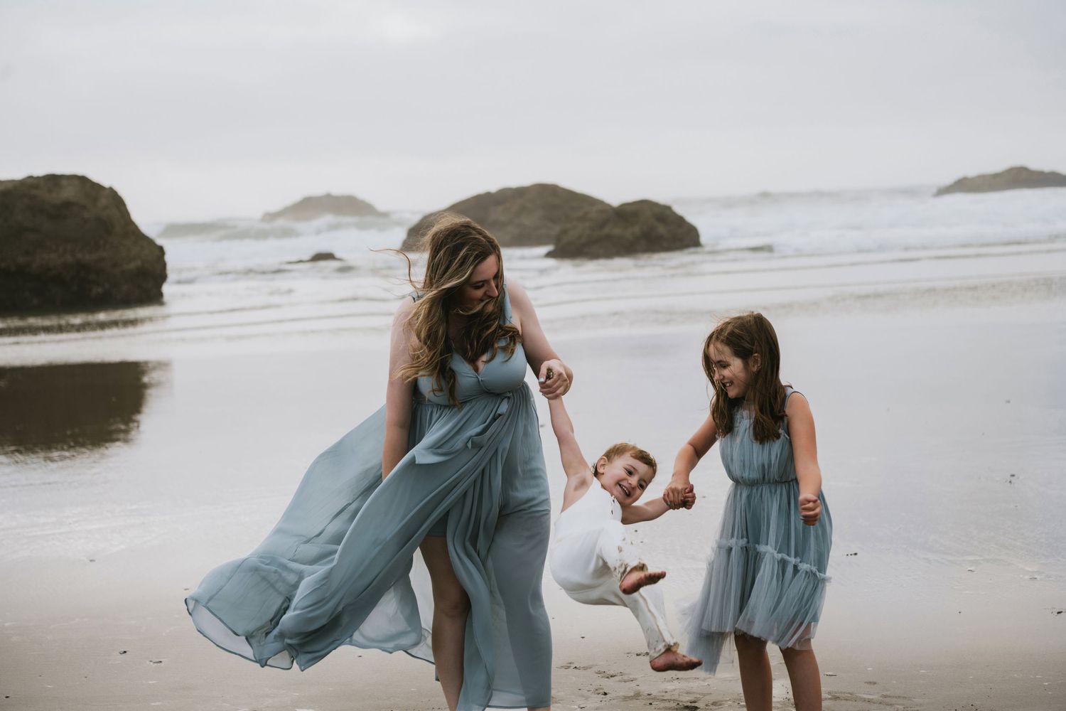 Brittani Smith walking along the beach with her children, sharing a candid moment together.