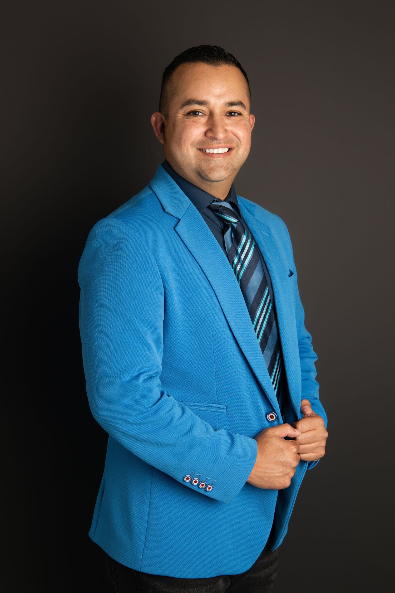 A man wearing a bright blue suit posing for a professional headshot image in Walla Walla.