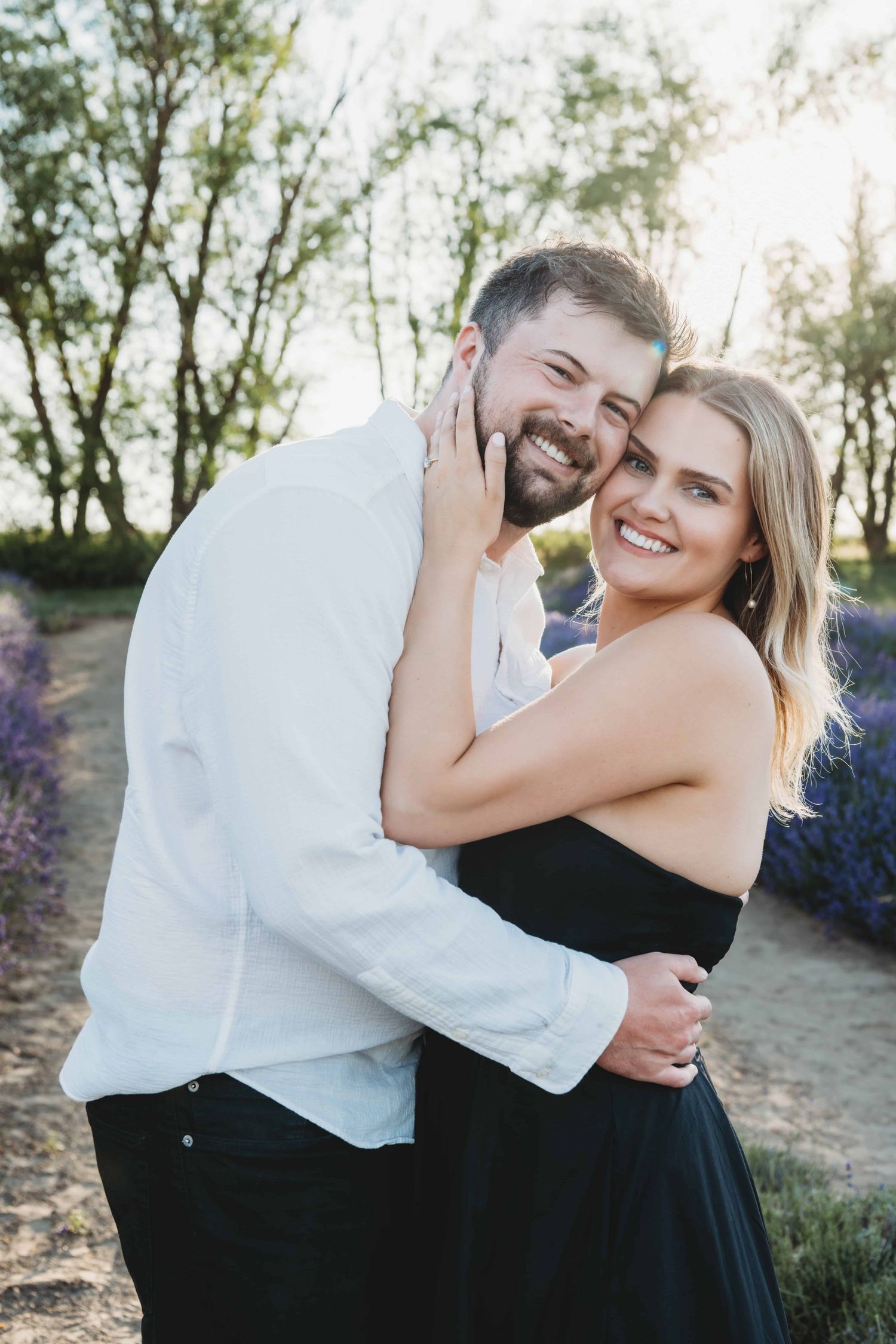 Engaged couple embracing in a lavender field during a Walla Walla engagement photo session.