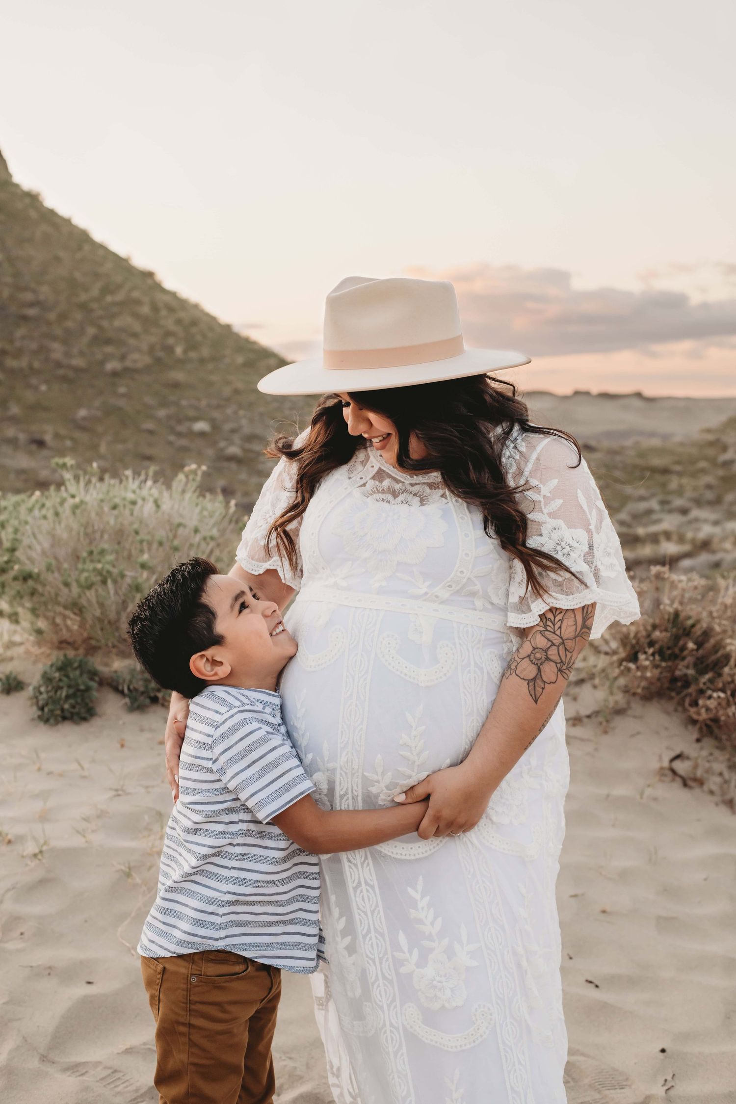 A pregnant mother looks down at her son during a maternity photography session in Walla Walla.