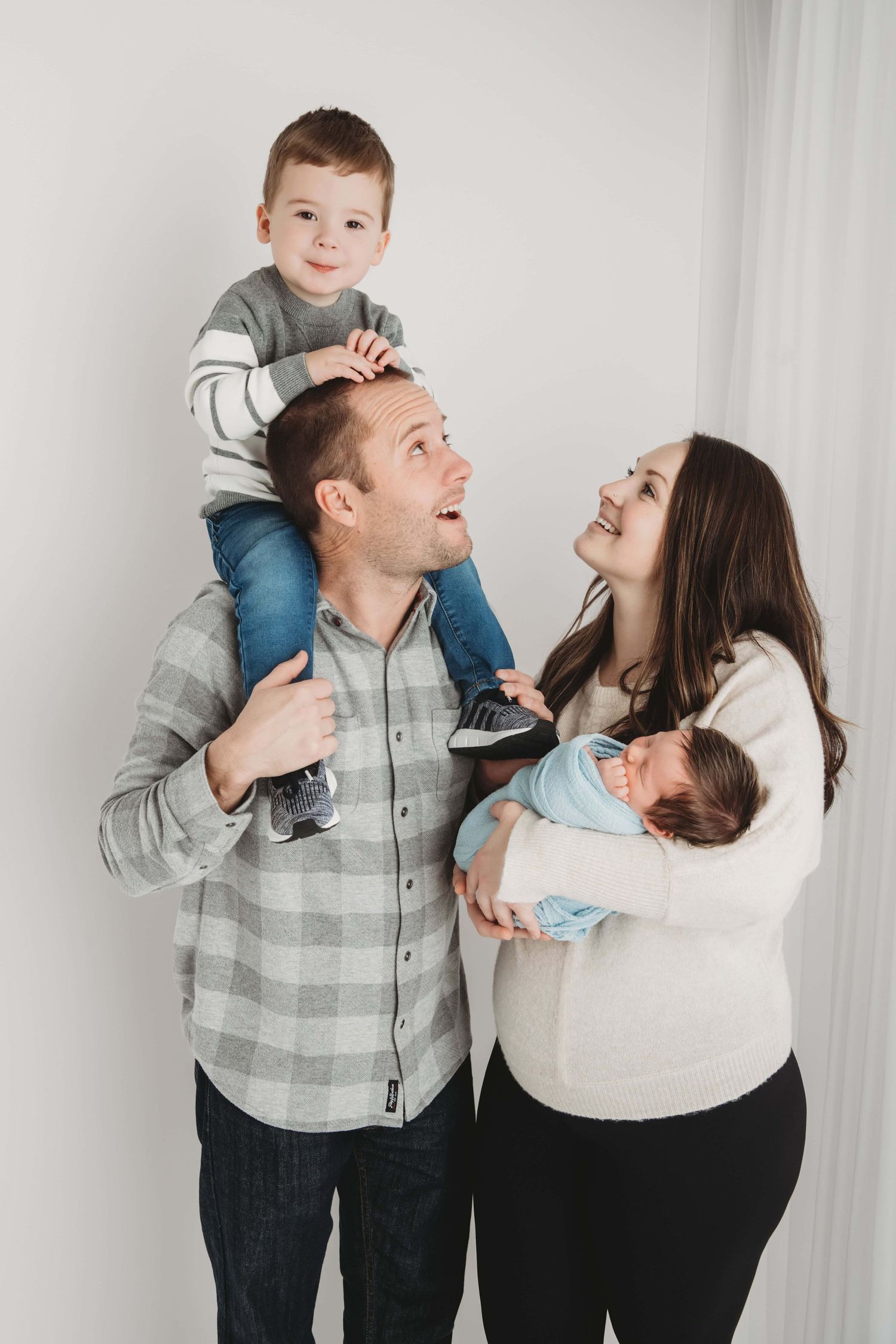 A candid portrait of a family of four in a Walla Walla photography studio.