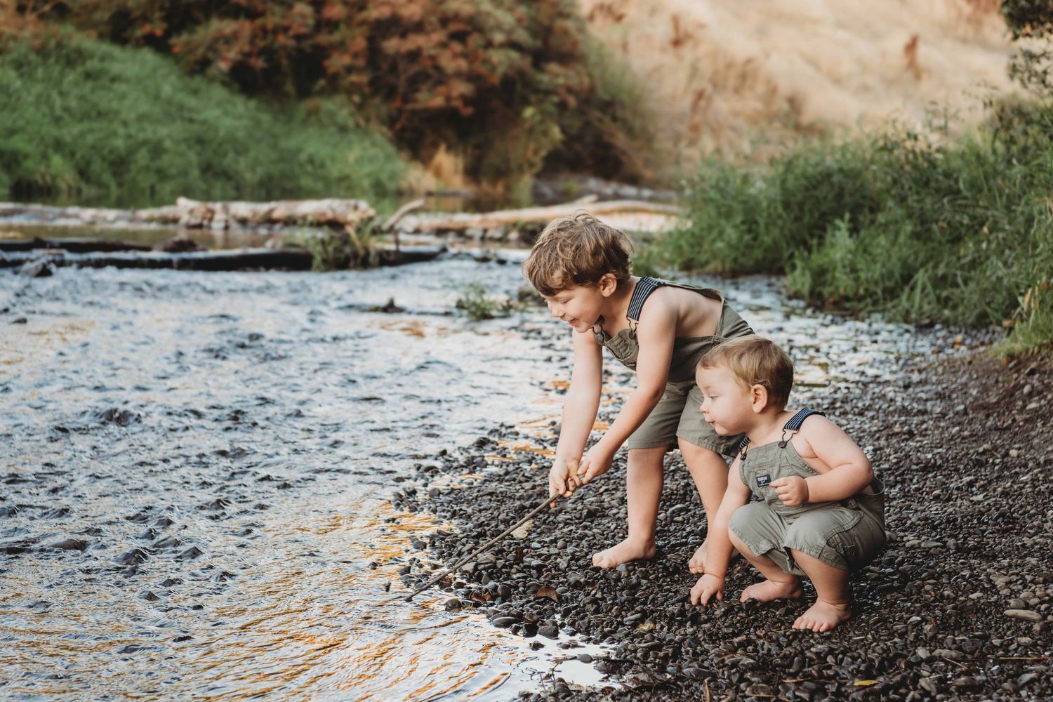A candid portrait of two boys playing in a creek in Walla Walla.