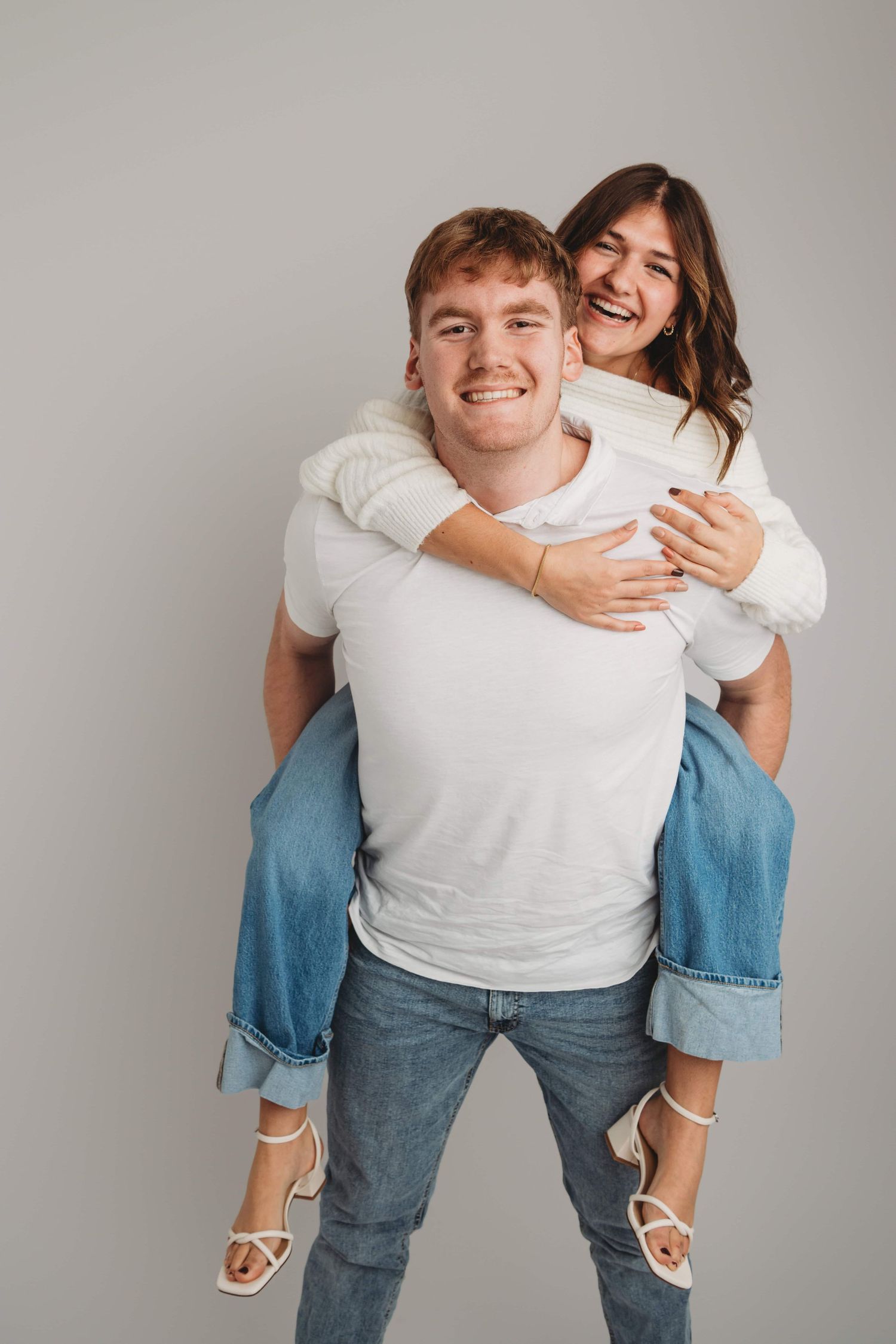 Playful studio couples portrait of a couple sharing a joyful moment in Walla Walla