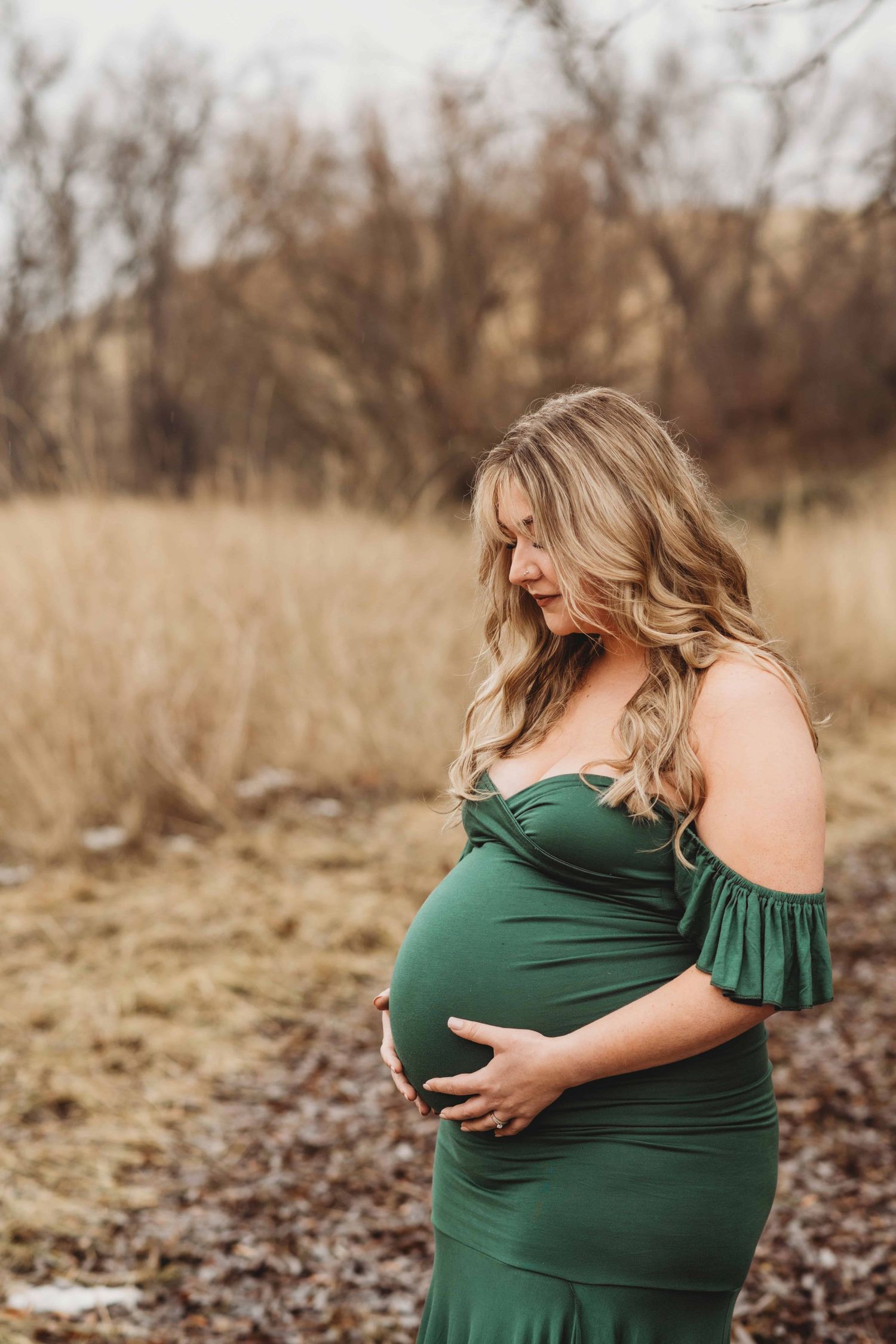 An expecting mother looks down at her belly during a maternity session in Walla Walla.
