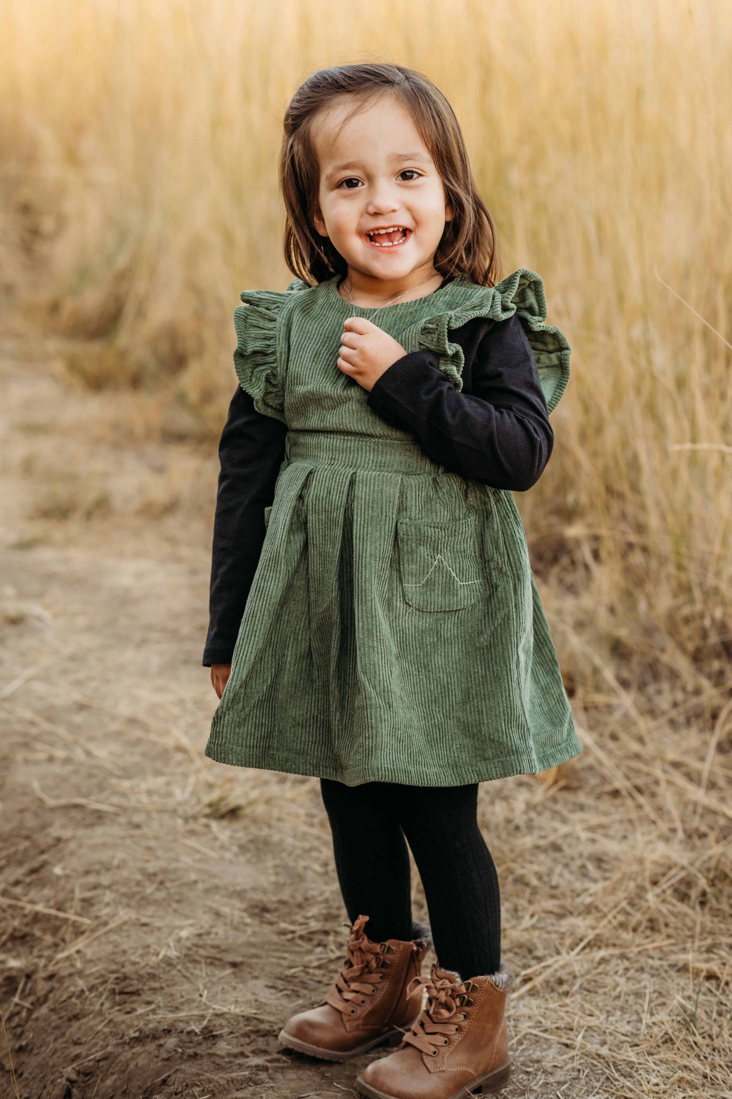 A portrait of a young girl looking at the camera and smiling.