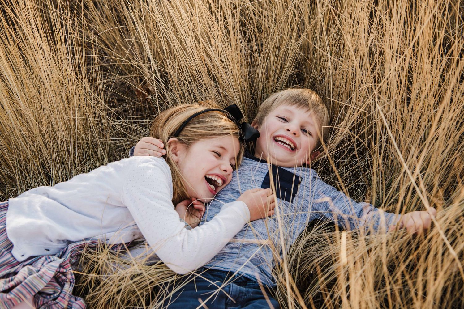 Two children playing together in a field in Walla Walla.