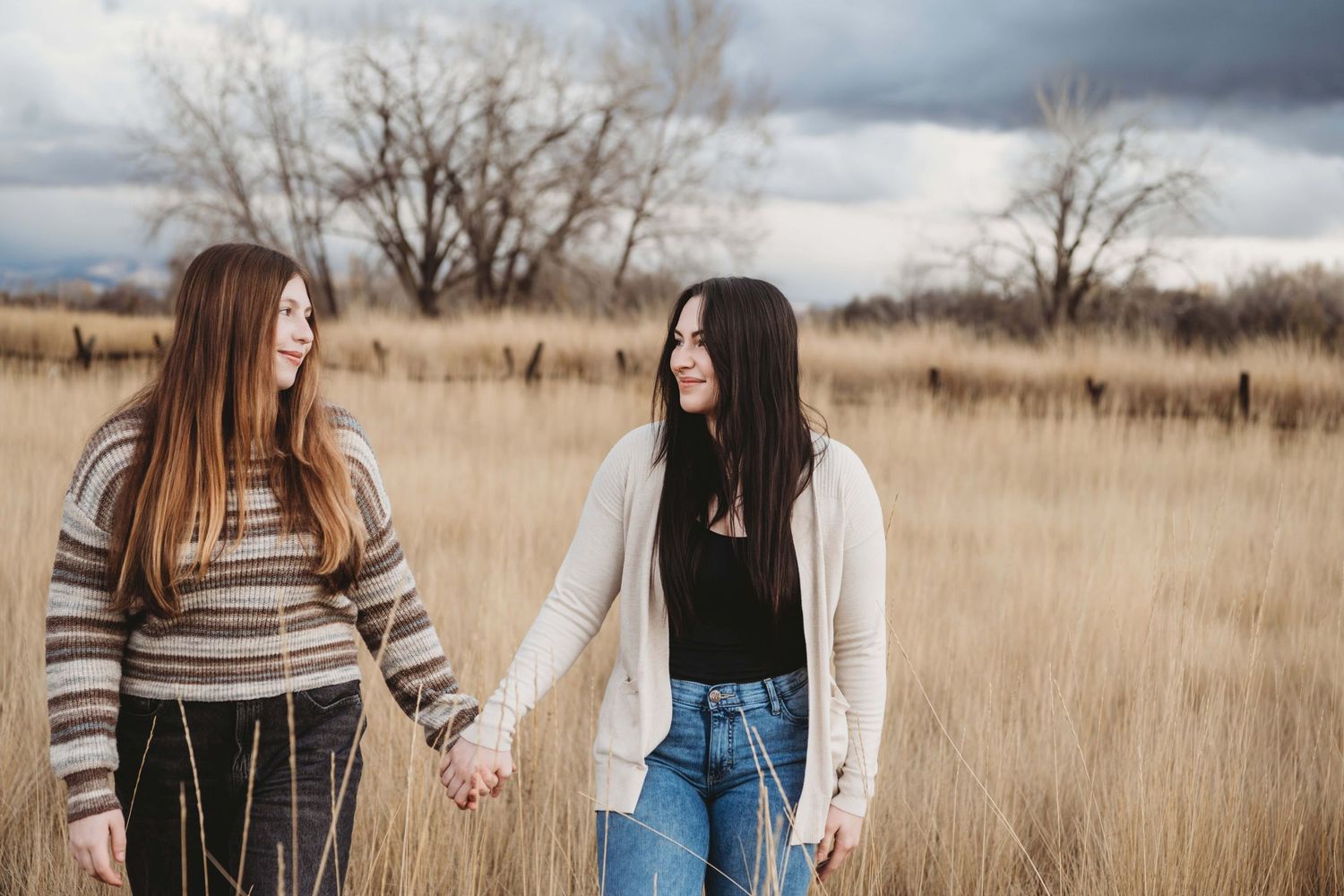 Two sisters walking together with stormy skies.