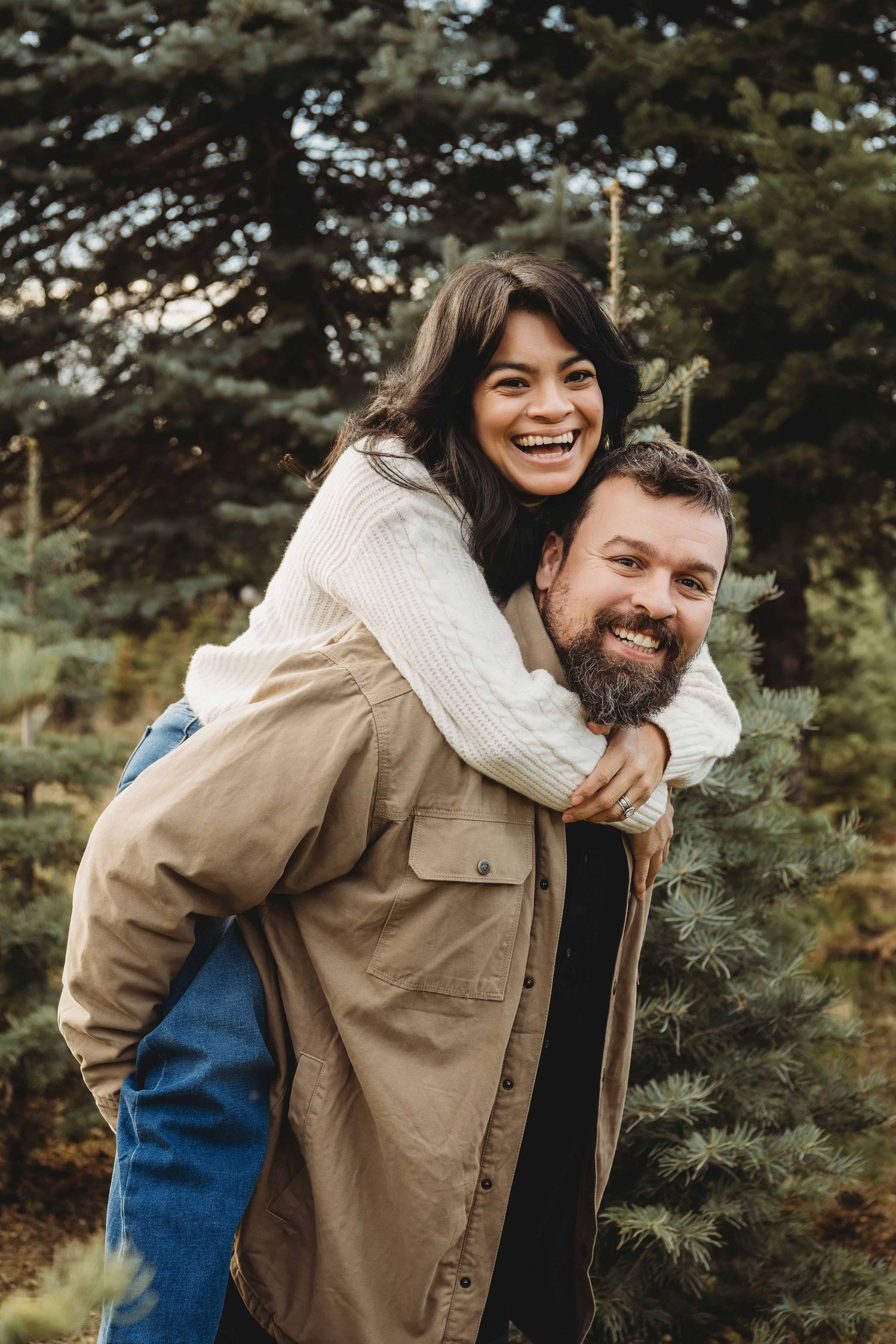 Playful couples portrait with one partner giving the other a piggyback ride during a Walla Walla couples session.