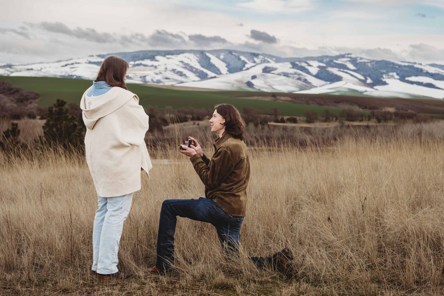 A man proposing to his girlfriend at Bennington Lake in Walla Walla, captured by a proposal photographer.
