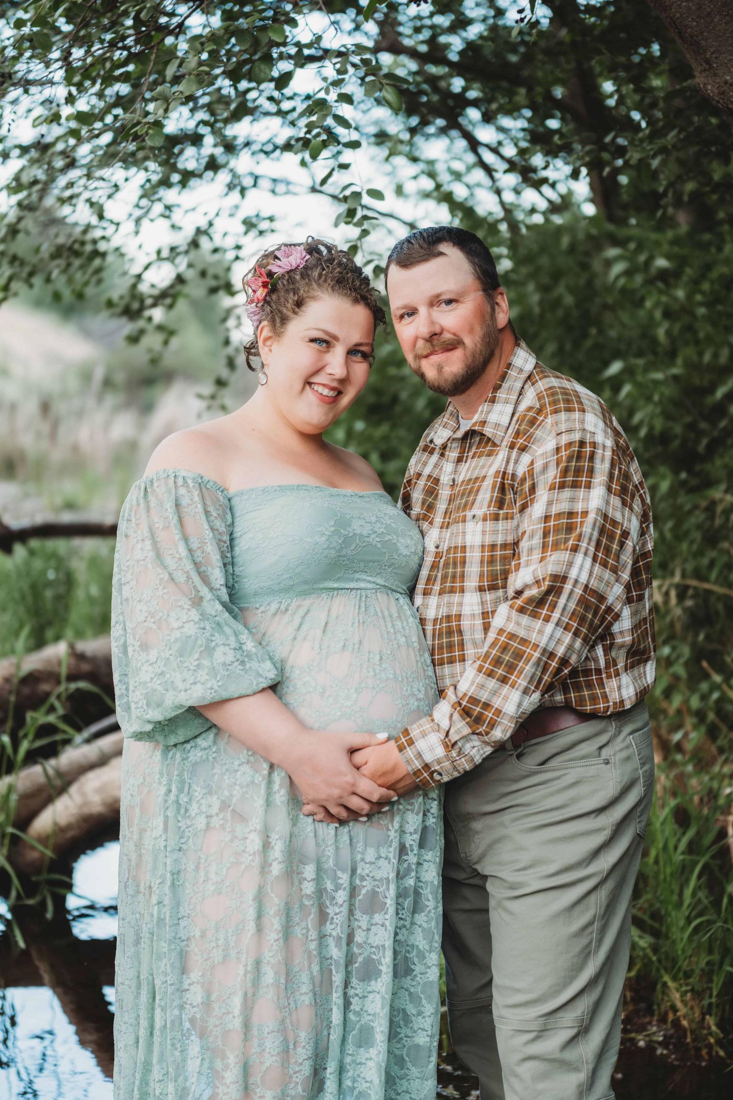 An expecting couple embraces while holding the baby bump during a maternity photography session in Walla Walla.