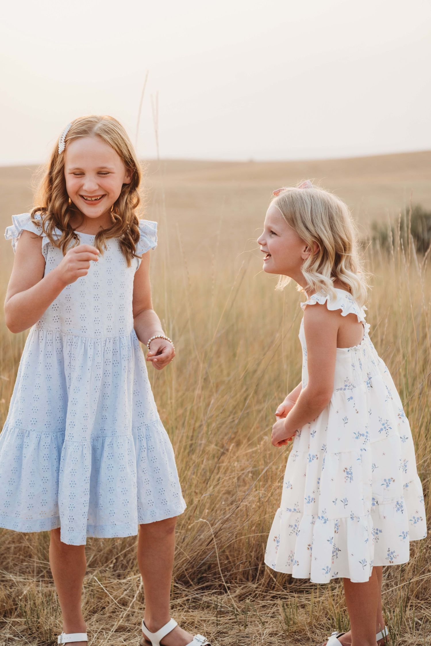 Two children laugh at each other in a candid portrait by Brittani Smith in Walla Walla.