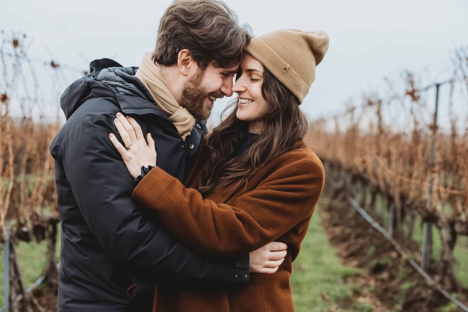 A newly engaged couple shares an intimate moment at Pepper Bridge Winery in Walla Walla, Washington.