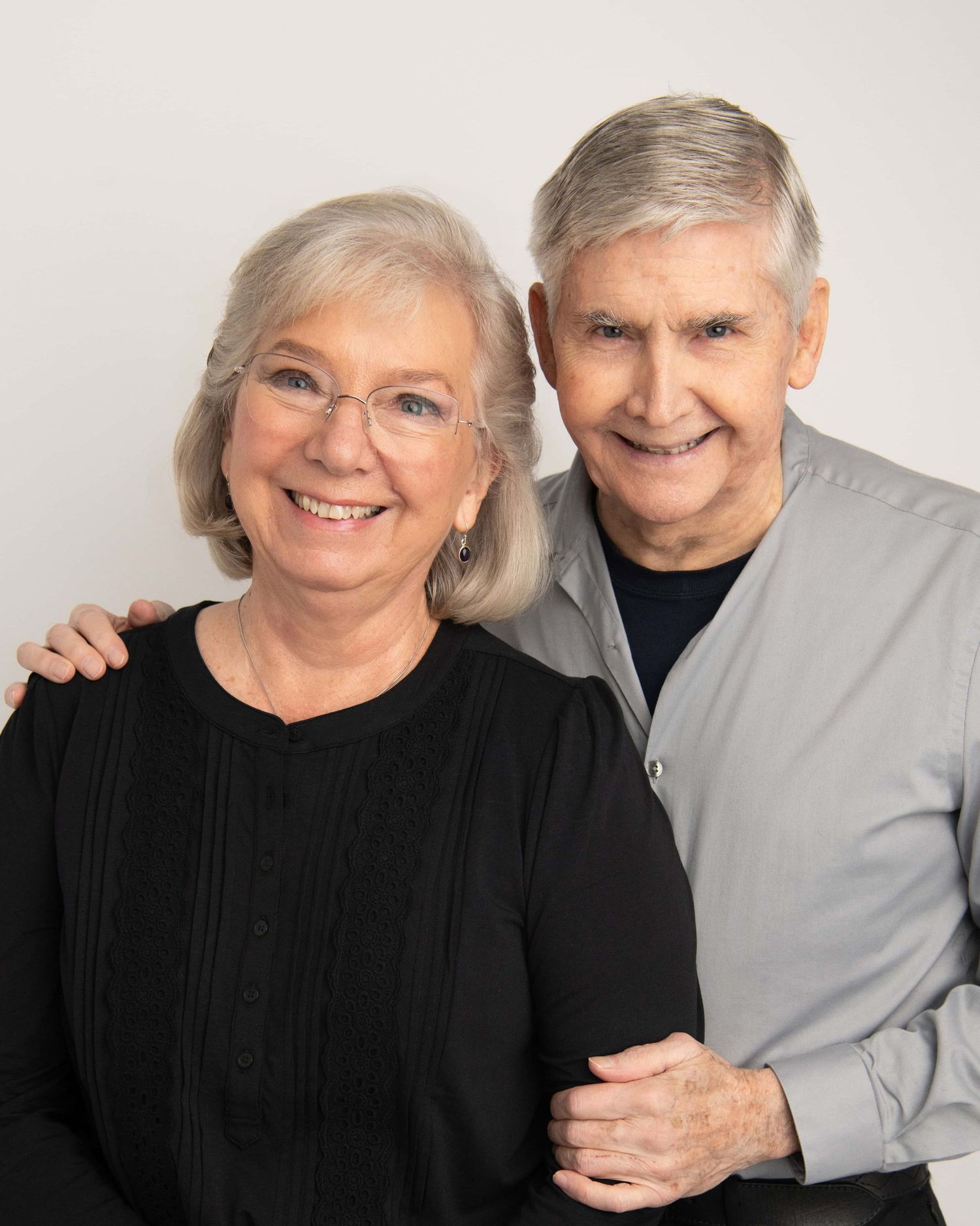 Classic studio portrait of an older couple standing together, photographed in a Walla Walla studio with simple, timeless styling.