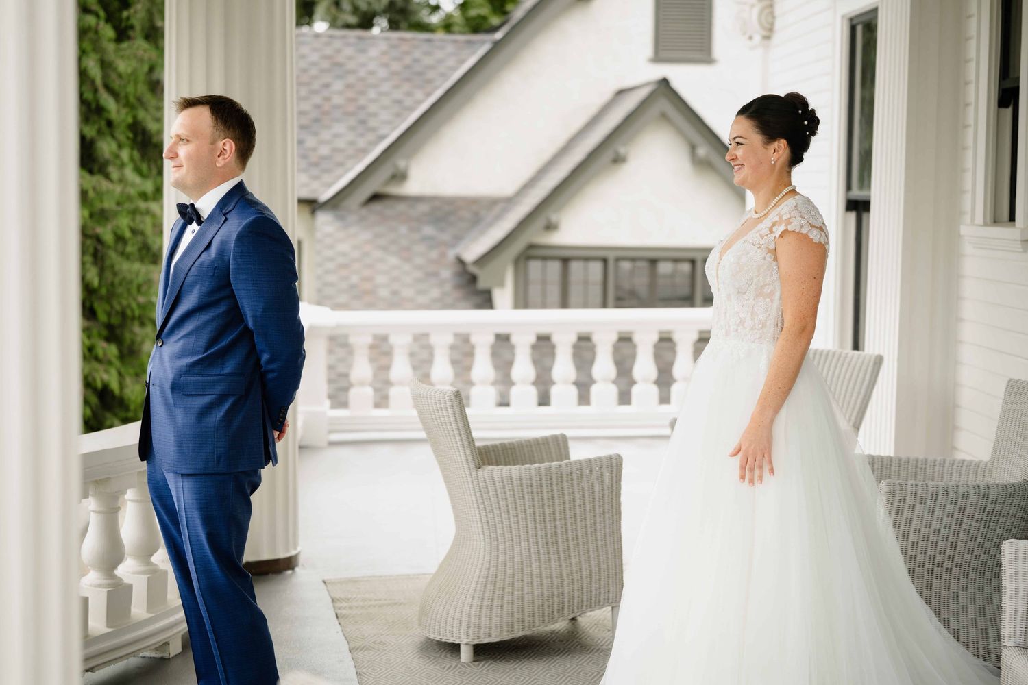 A woman walking up to her groom just before he turns around to see her for their first look before the wedding ceremony.