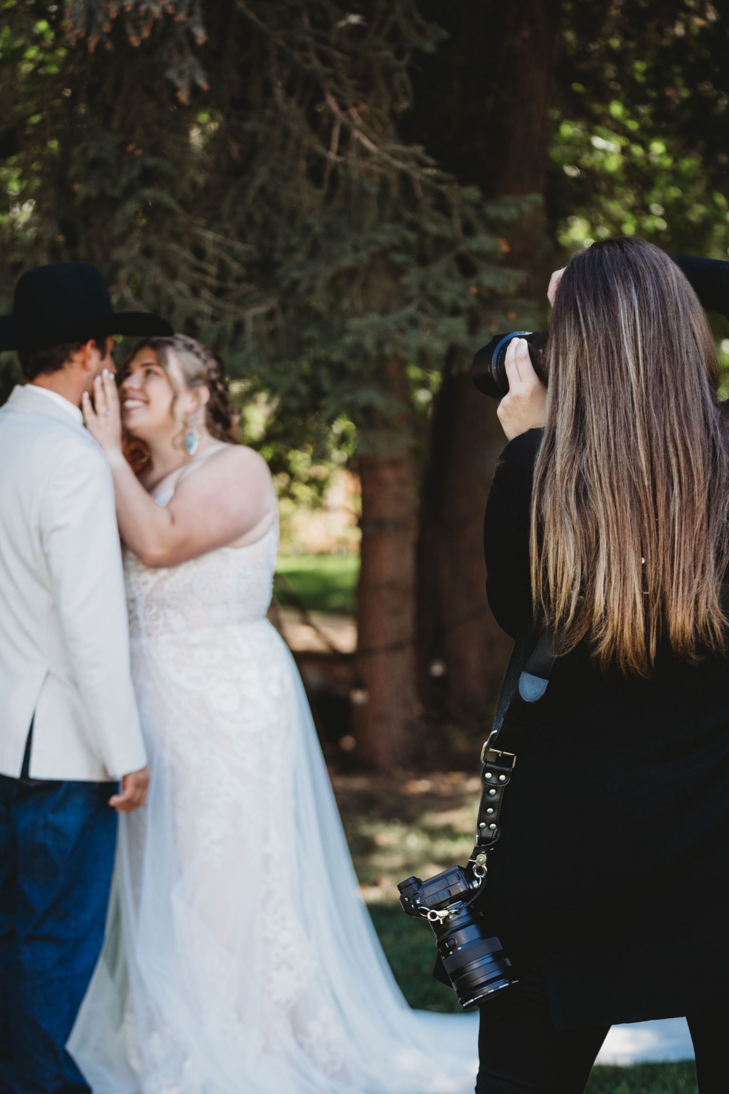 A behind the scenes image of Brittani photographing a bride and groom.