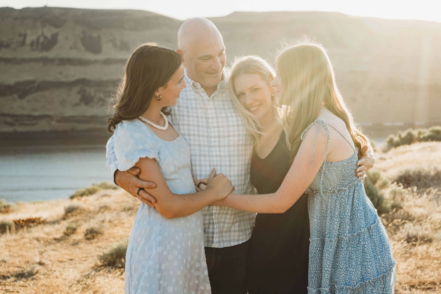 A family with two teenage daughter's hugging at Twin Sisters near Walla Walla.