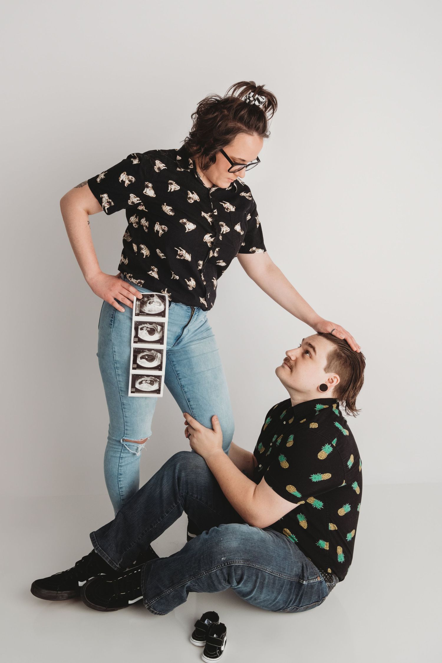 Creative maternity couples photo with ultrasound images in a Walla Walla portrait studio