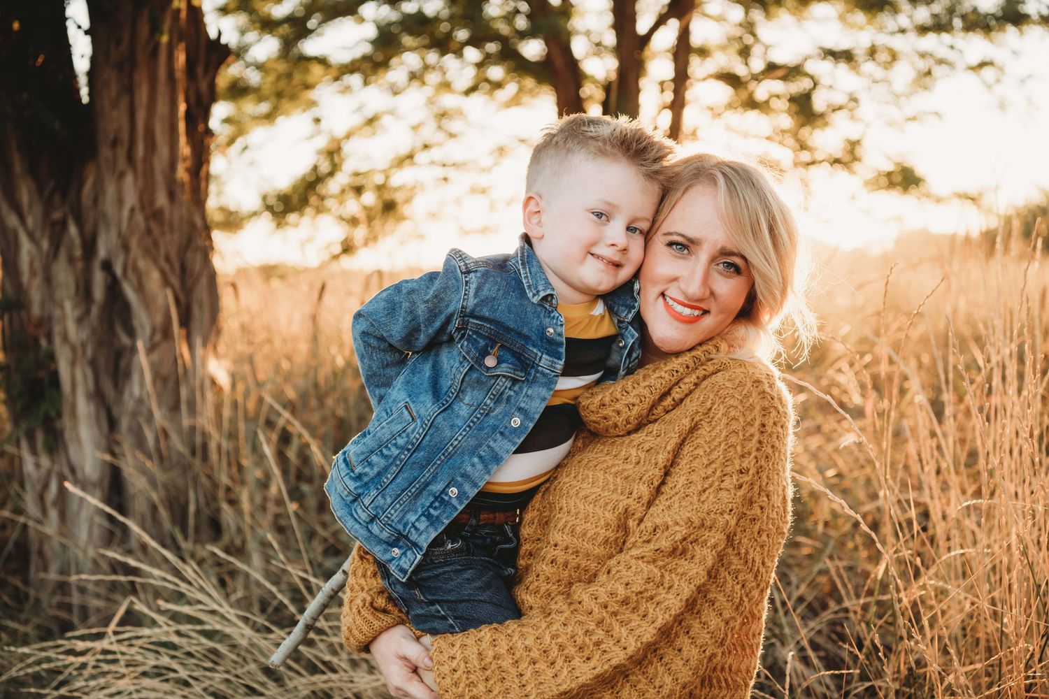 Mother and son portrait by a Walla Walla photographer showing a smiling parent holding her child at sunset.