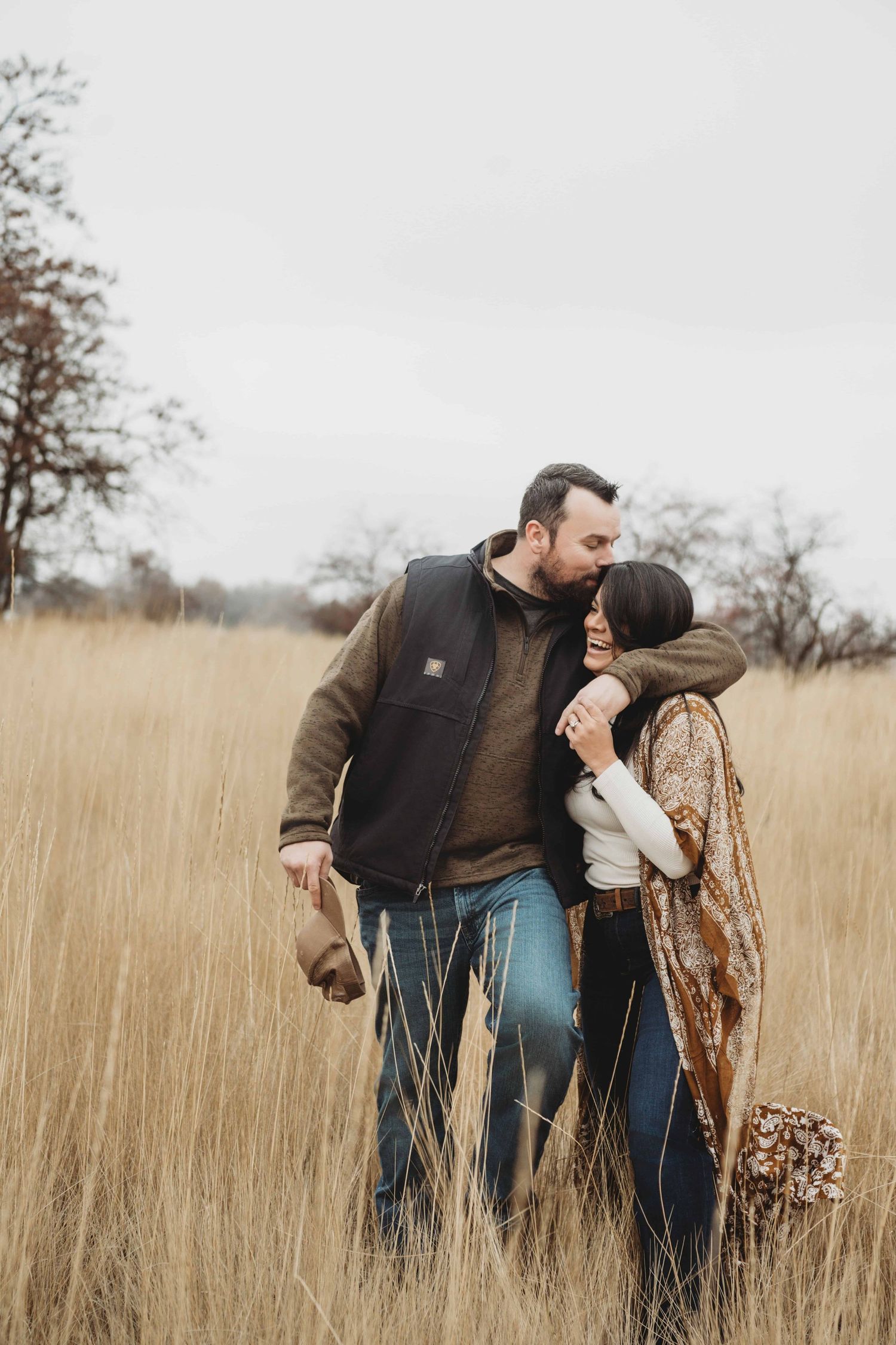 A couple walking closely together in a field in Walla Walla.