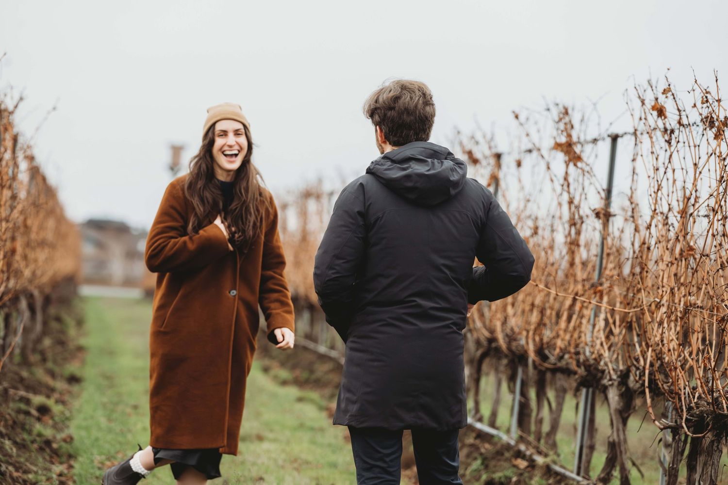 A woman laughing with excitement just after her boyfriend proposed to her in a vineyard in Walla Walla.