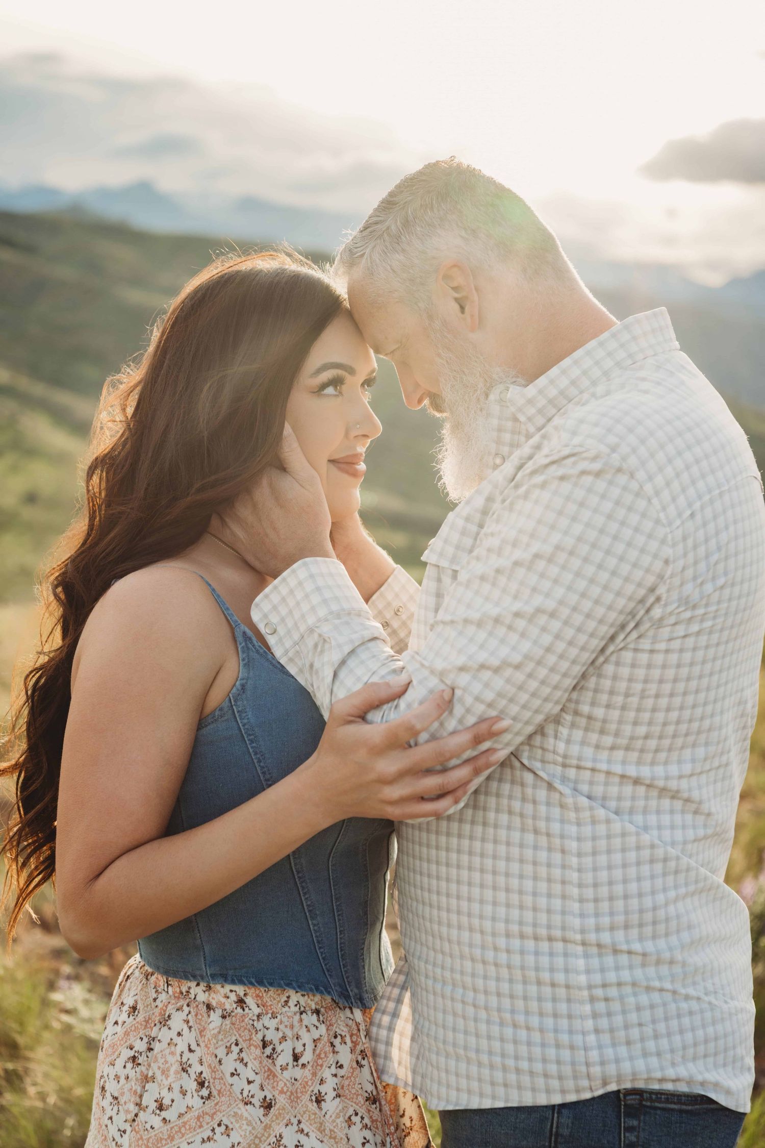 A couple looking at each other during a quiet intimate moment in the golden hour sun.