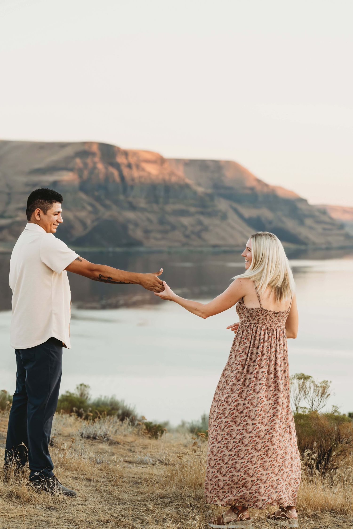 A portrait of a couple dancing above the Columbia River with Wallula gap in the background taken by a Walla Walla photographer.