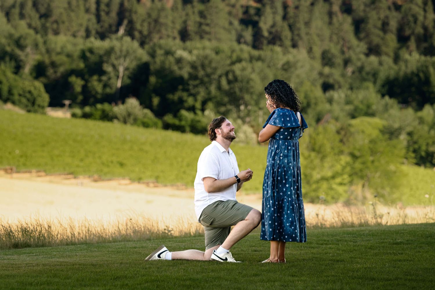 A woman covers her face as her boyfriend proposes to her at Echolands Winery in Walla Walla.