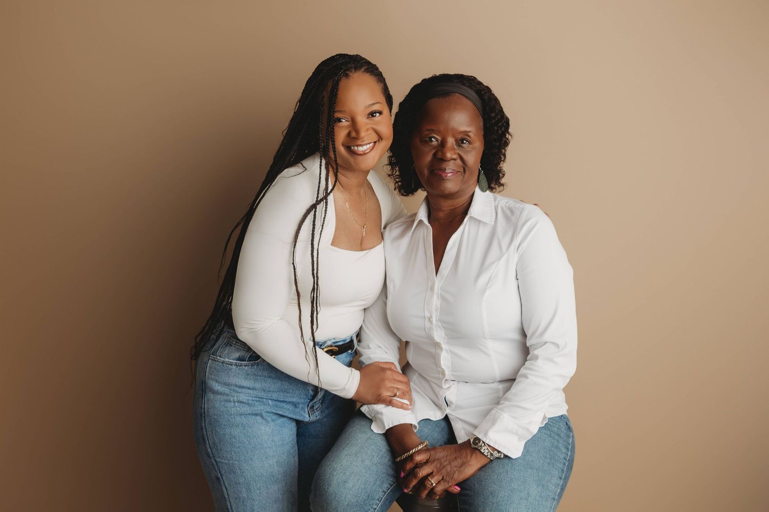 A mother and daughter posing for a portrait looking at the camera at a Walla Walla photo studio.