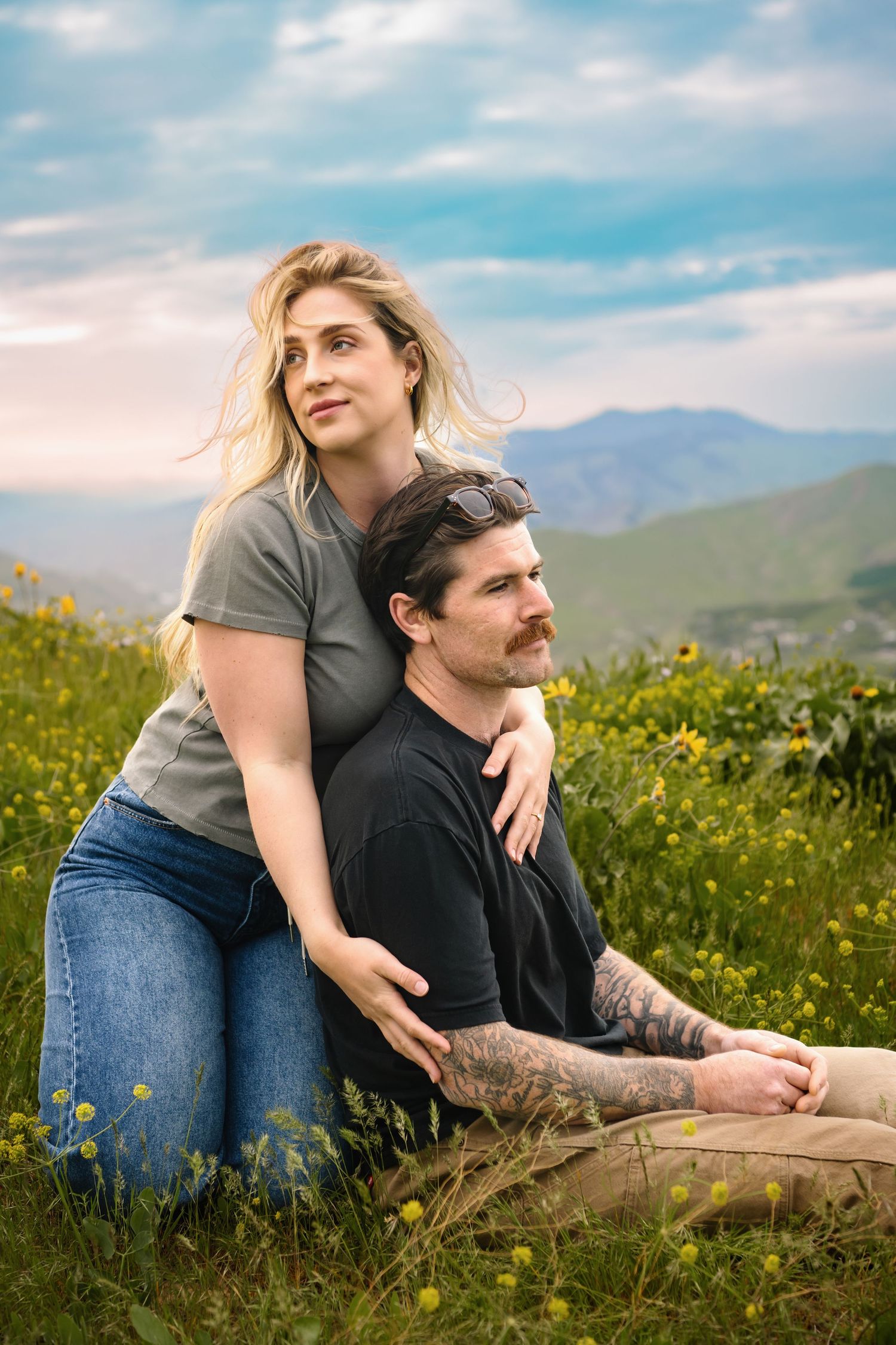 A couple sitting in a wildflower field in Wenatchee Washington