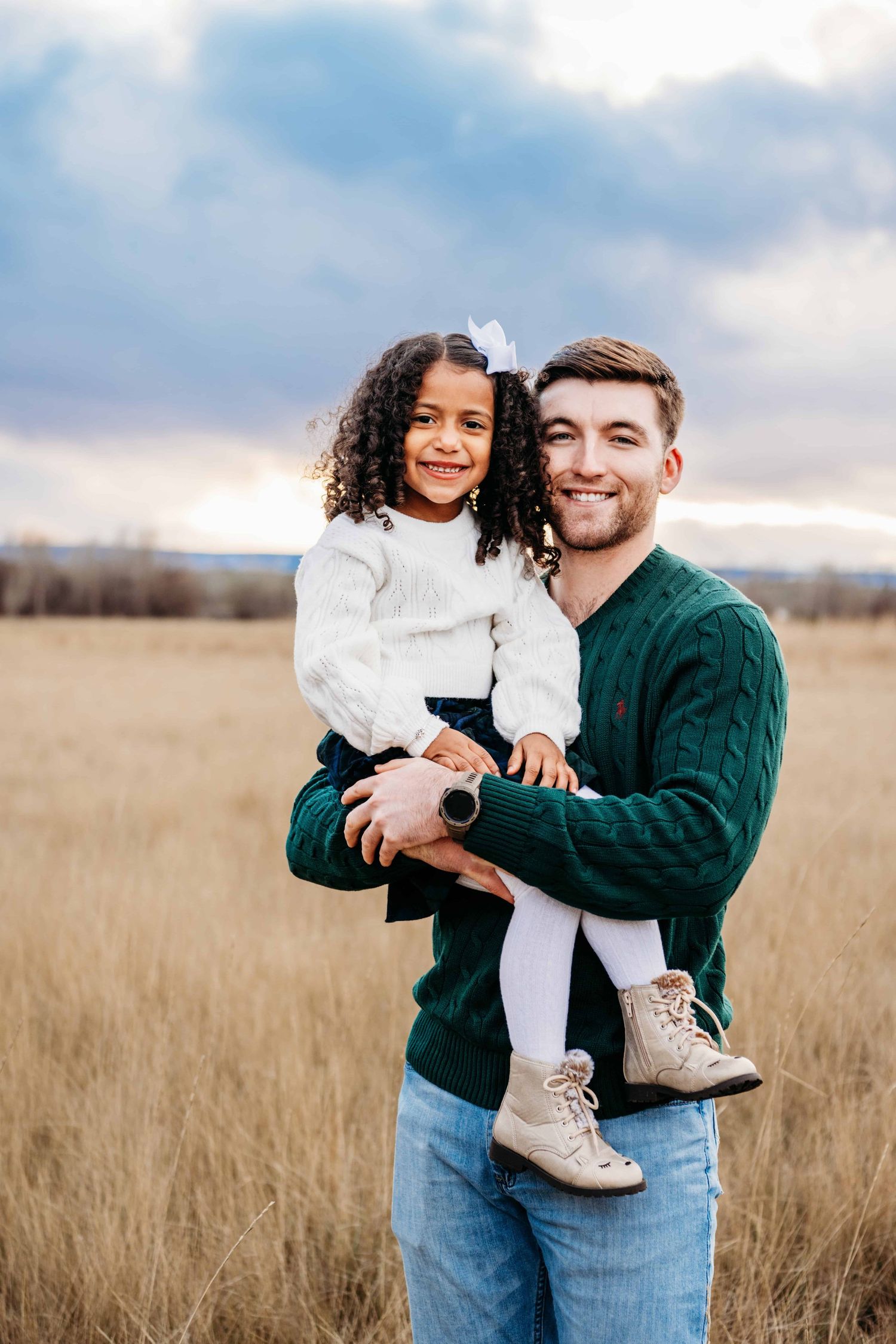 A portrait of a father holding his daughter at Whitman Mission in Walla Walla.