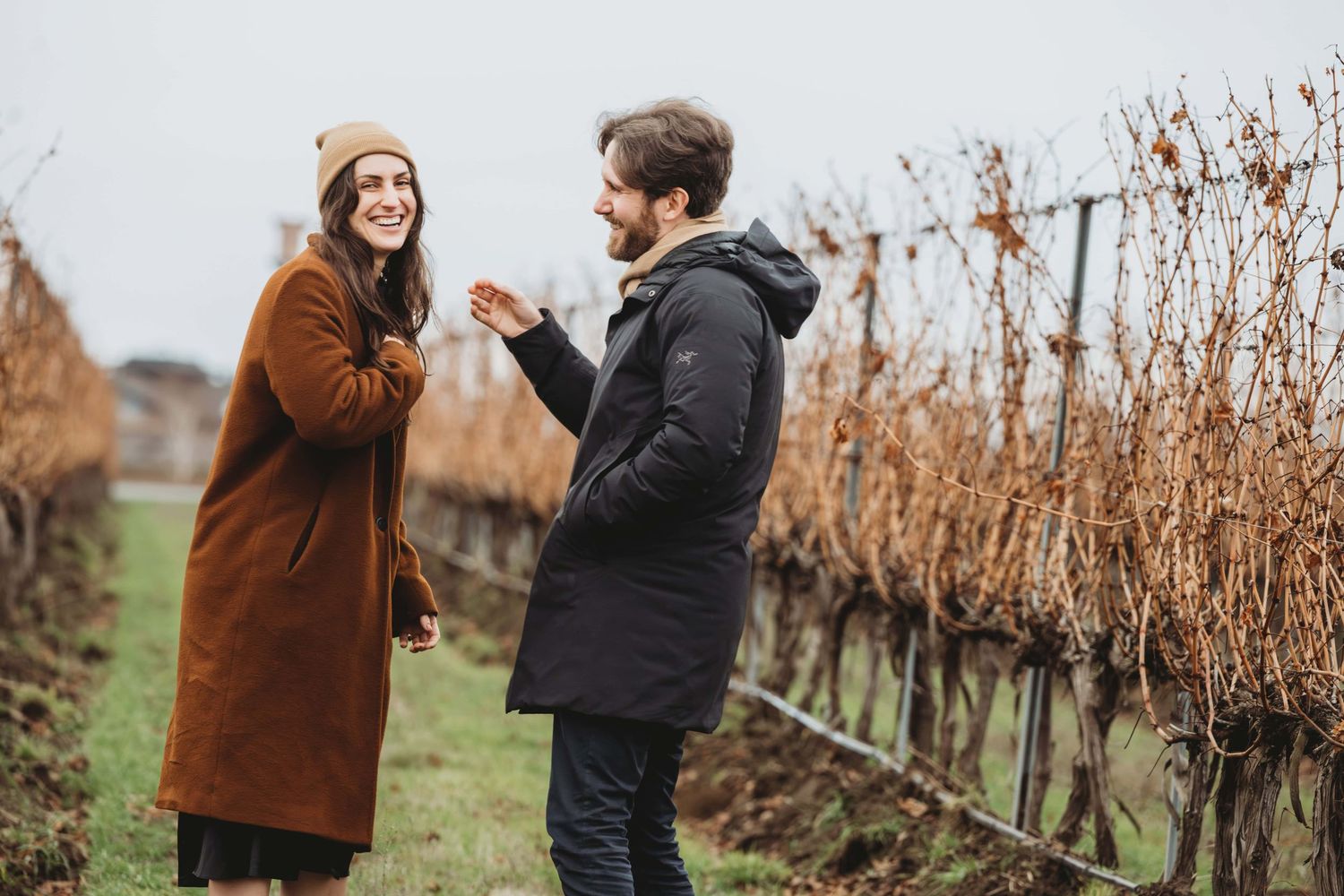 A couple laughing excitedly just after getting engaged on a cool overcast winter day in Walla Walla.