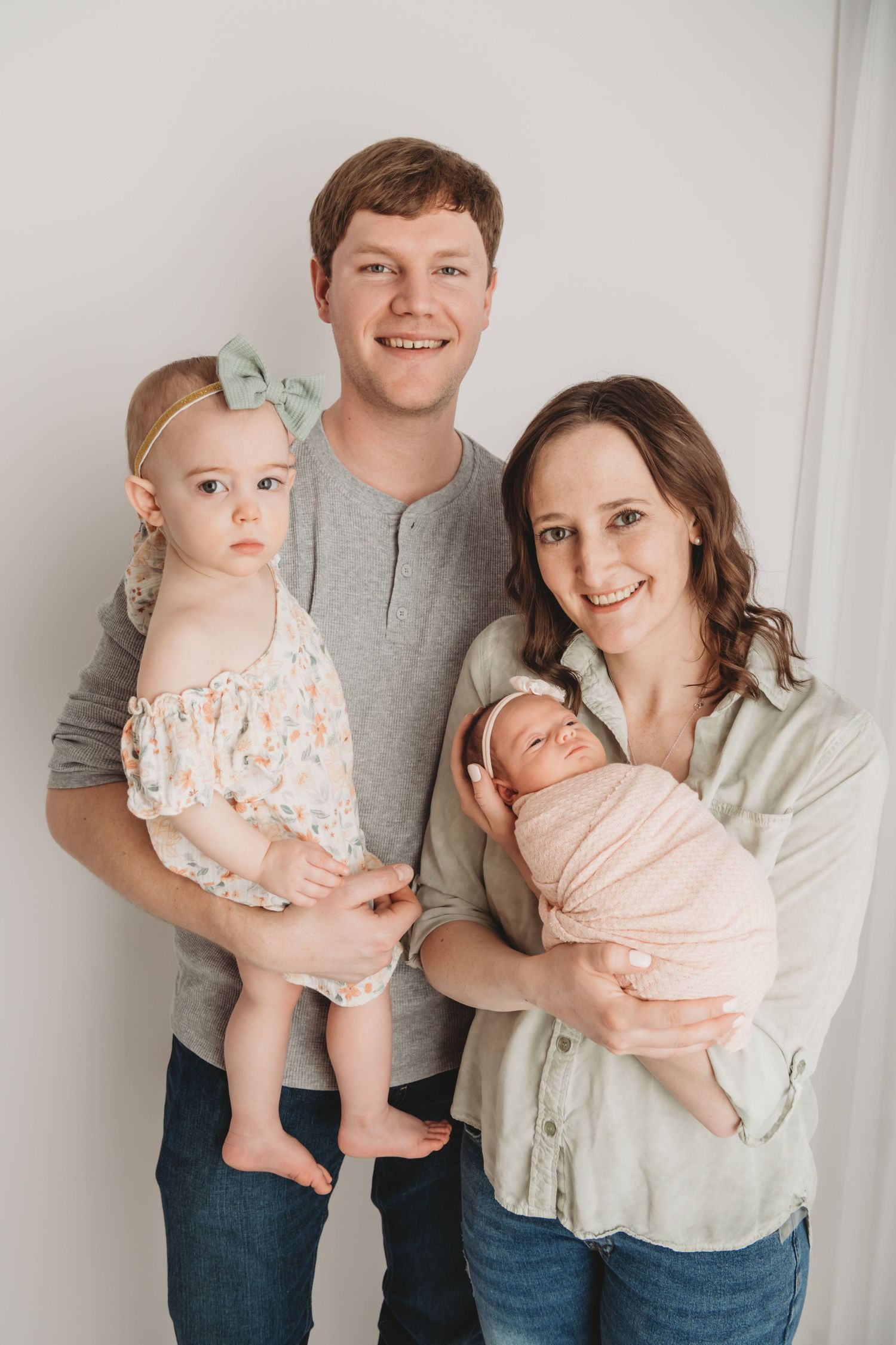 A portrait of a family with their newborn baby in a Walla Walla photography studio.