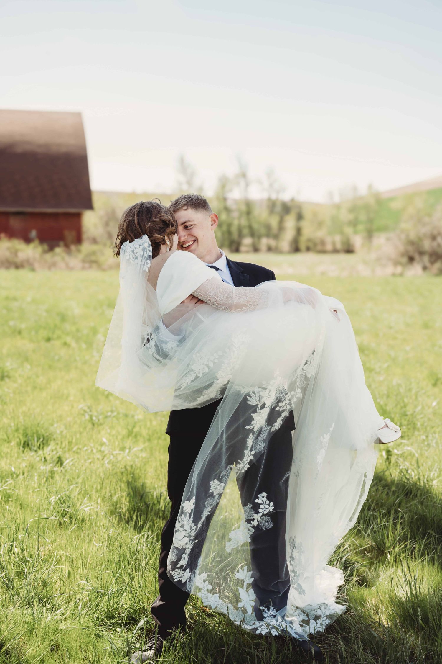 Groom picking up his bride on a sunny day in Walla Walla.