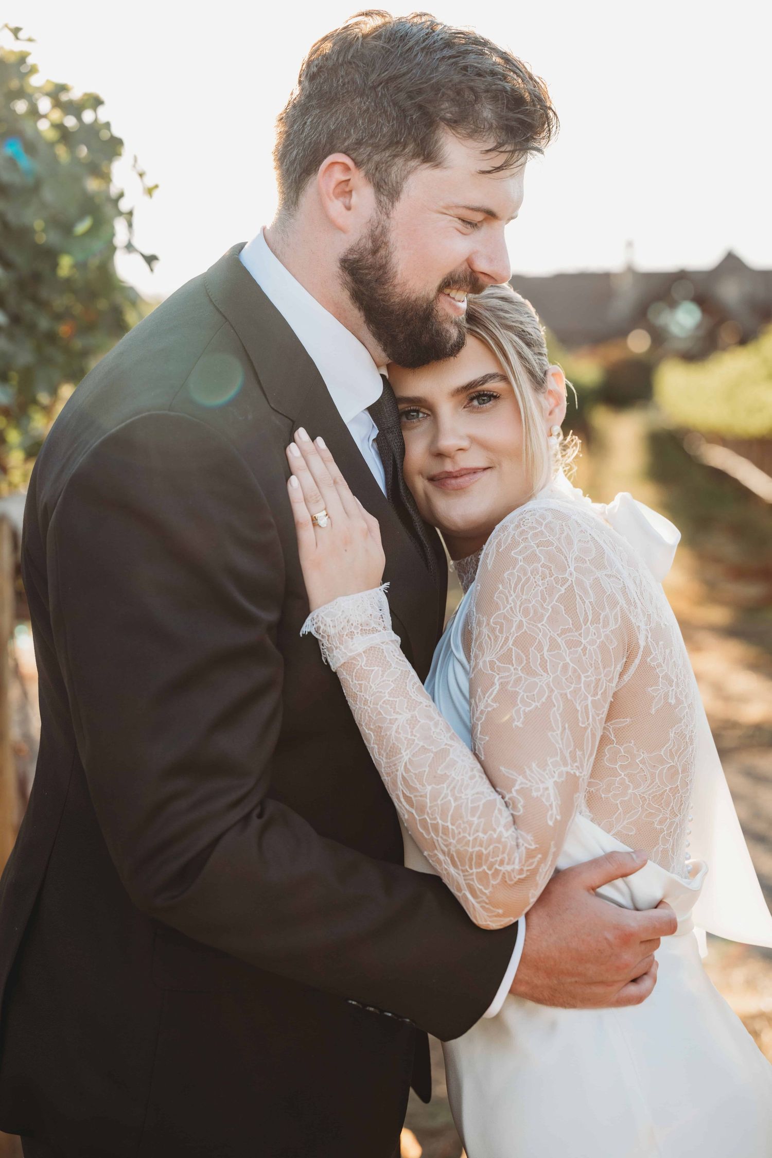 A portrait of a woman laying her head on her new husband's shoulder, taken by a Walla Walla Wedding Photographer.