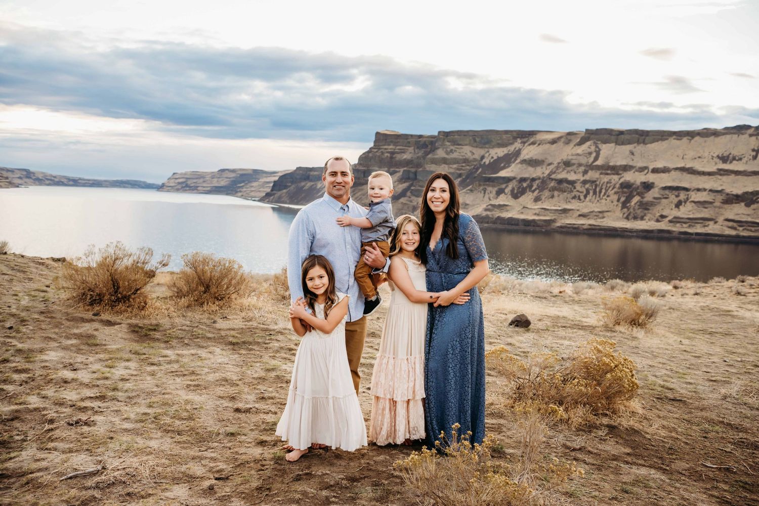 A family standing with the Columbia river behind them, smiling at the camera.