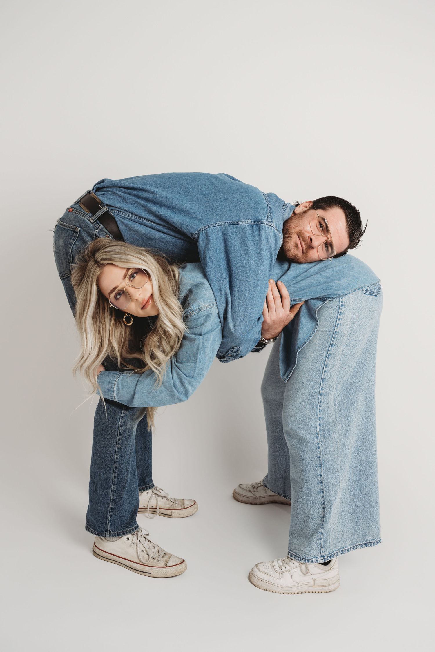 Studio couples portrait of a playful couple in denim outfits photographed in a Walla Walla photography studio