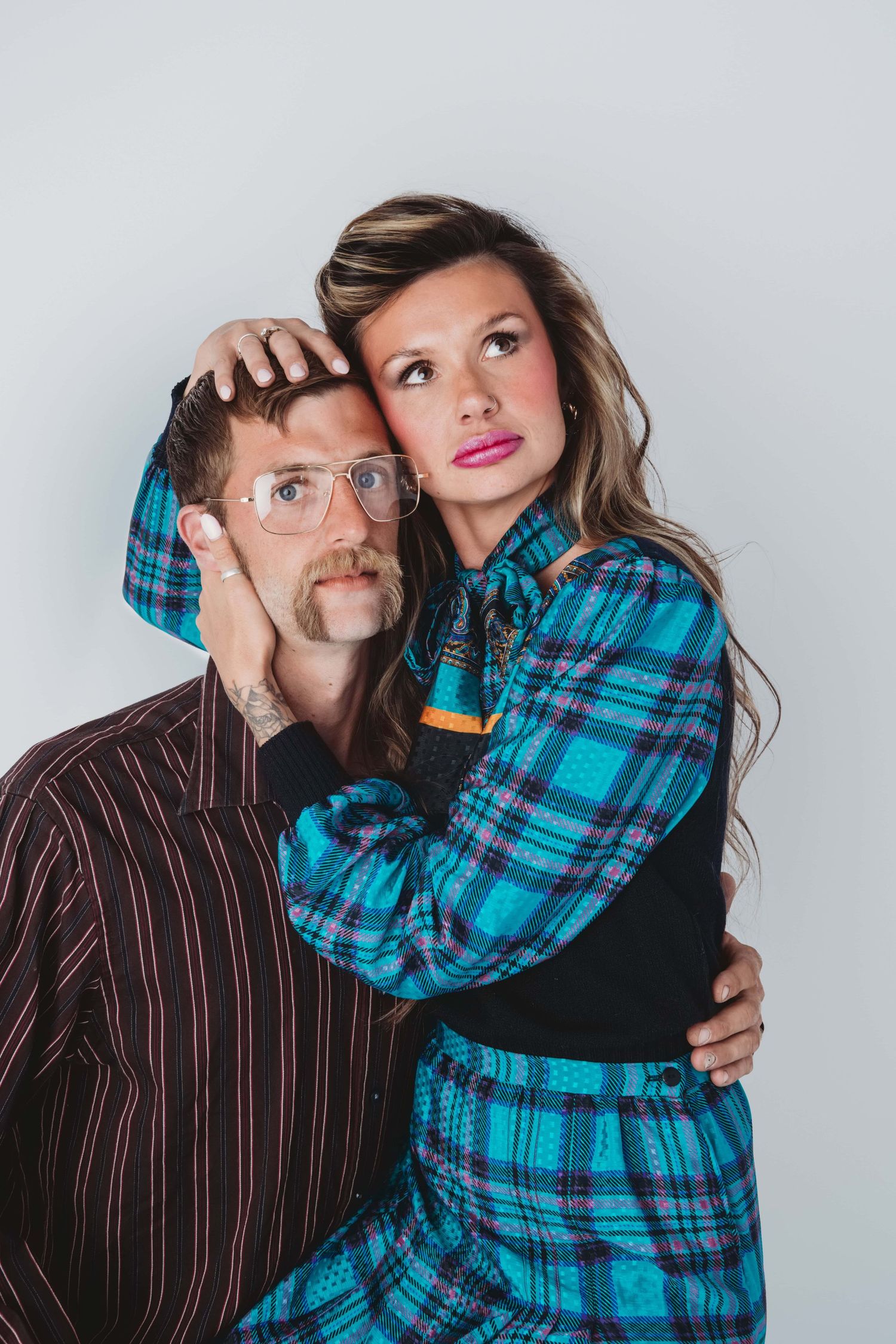 Editorial-style studio couples portrait with bold fashion captured in Walla Walla