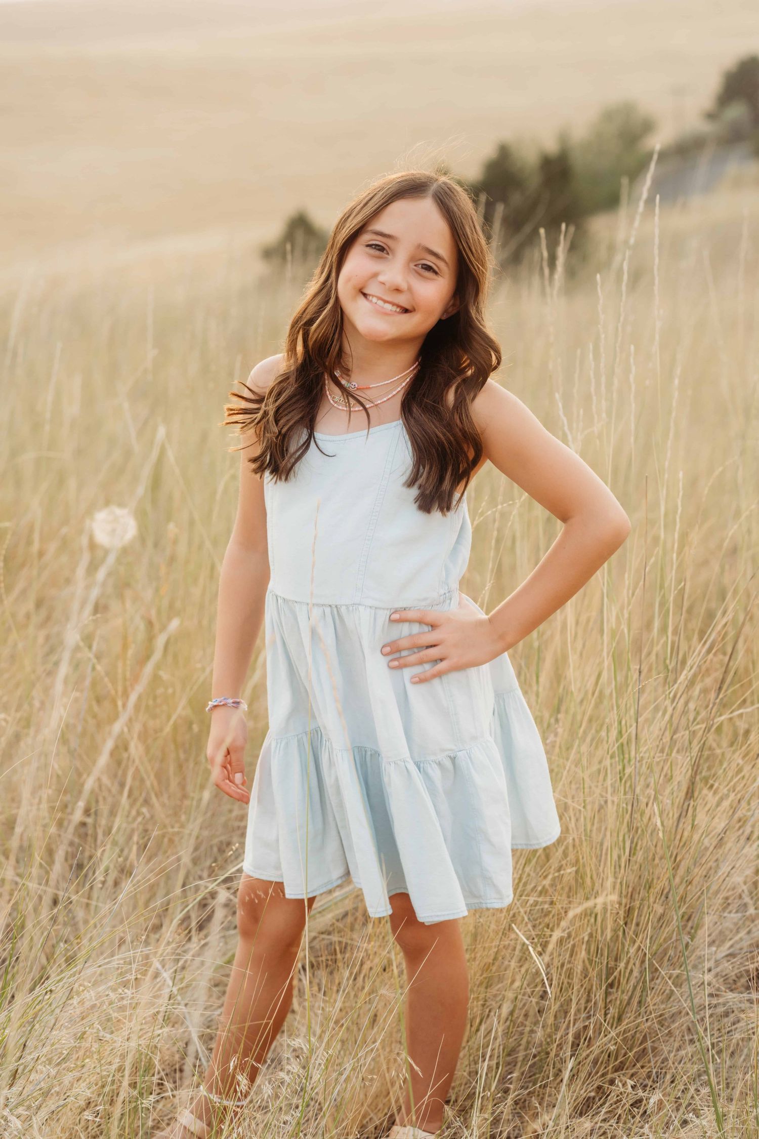 A portrait of a girl wearing a blue dress standing with her hand on her hip at Bennington Lake taken by a Walla Walla photographer.