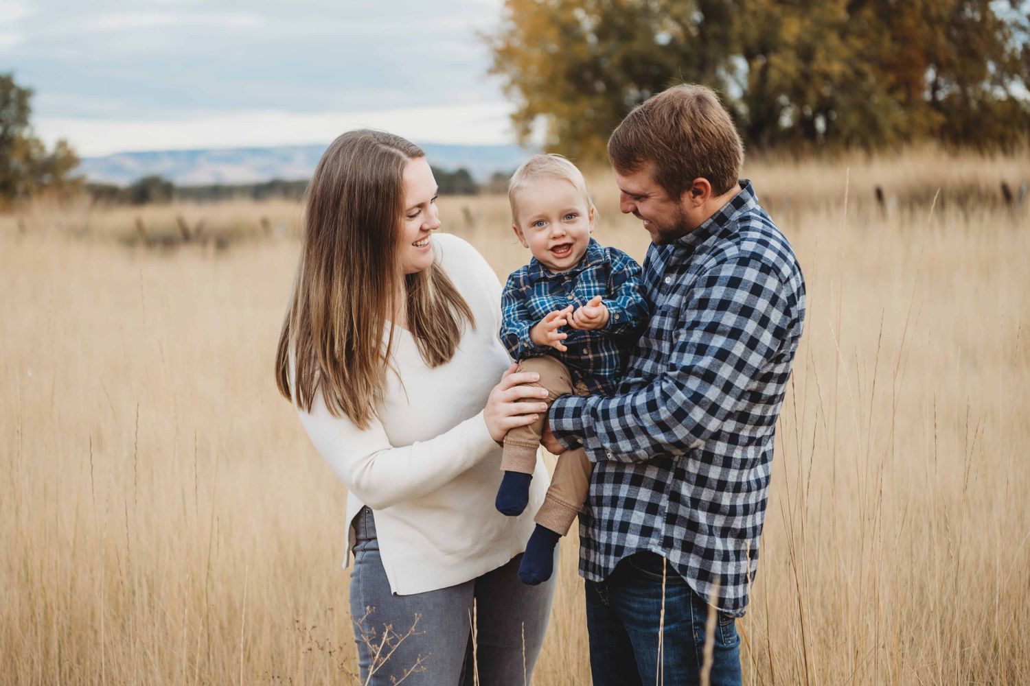 A candid portrait of a family playing with their baby.